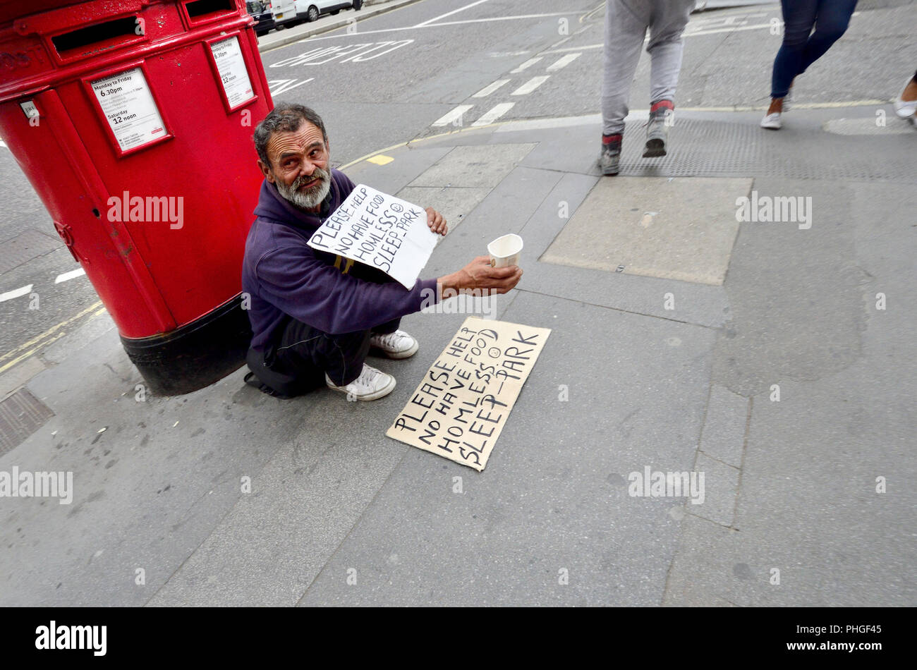 Homeless man begging in the street. London, England, UK 2018 Stock Photo