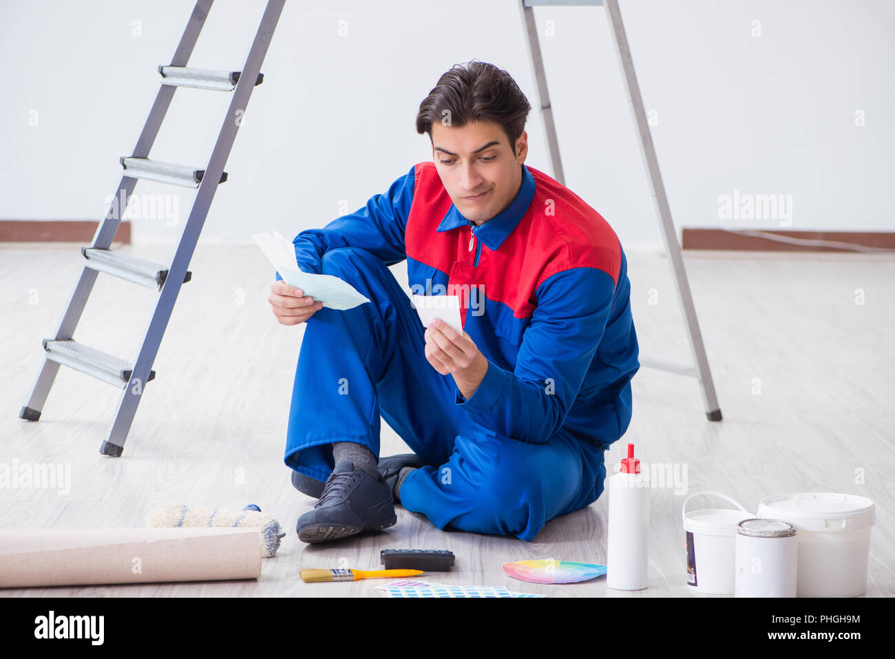 Young painter trying to match colours for painting job Stock Photo Alamy