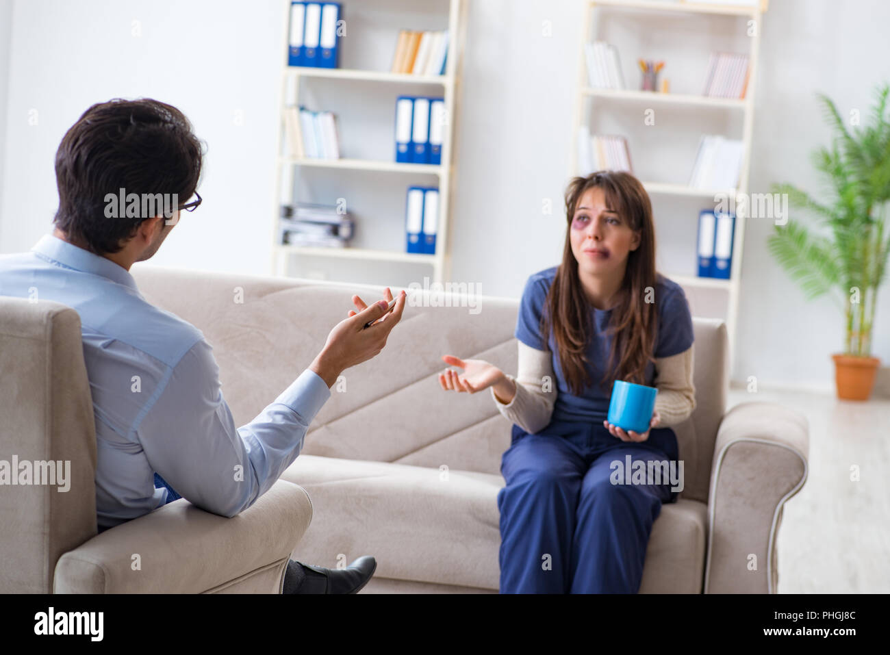 Psychologist counselling woman beaten by husband Stock Photo