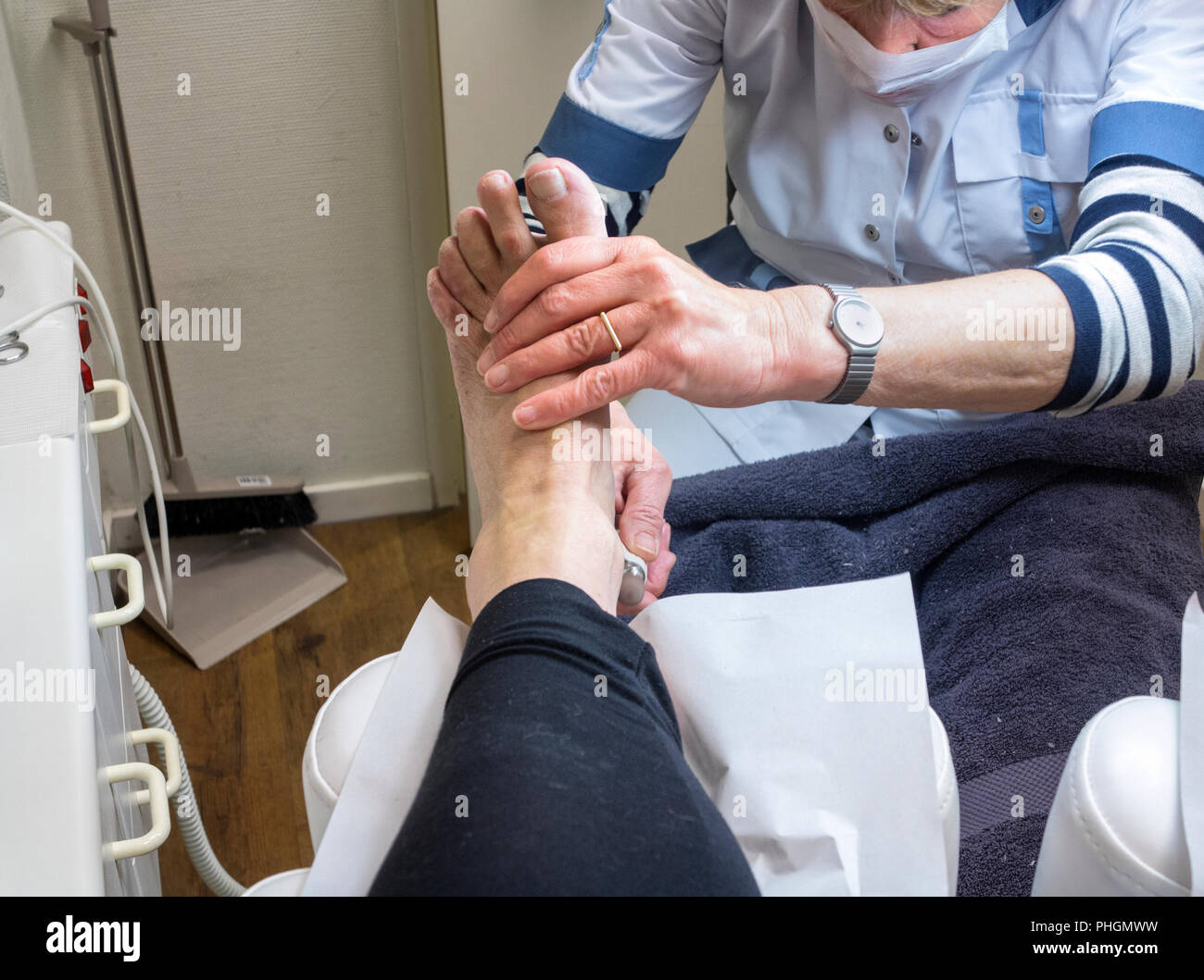 Pedicurist at work on a woman foot in a beauty salon. Stock Photo