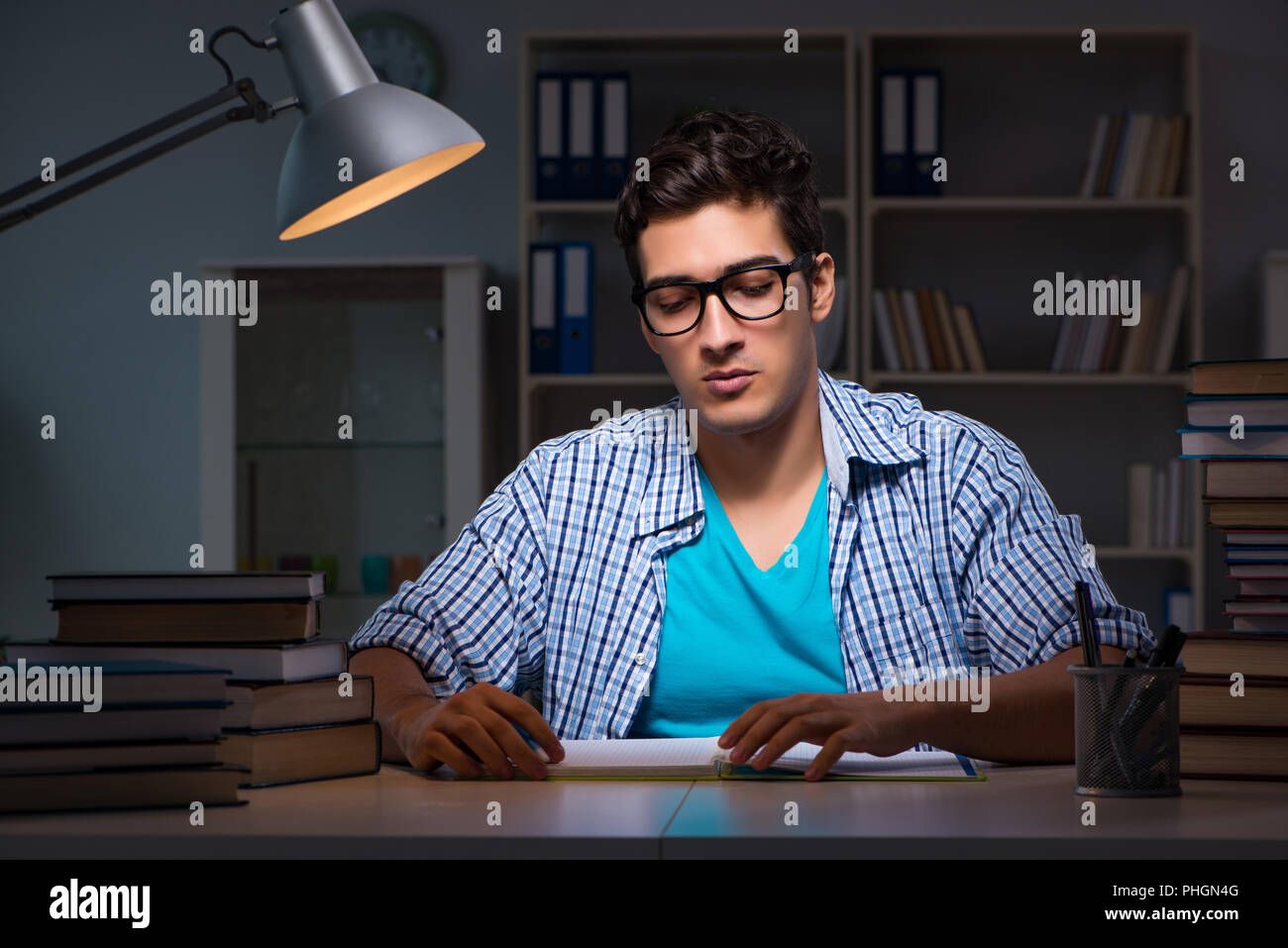 Student preparing for exams late night at home Stock Photo - Alamy