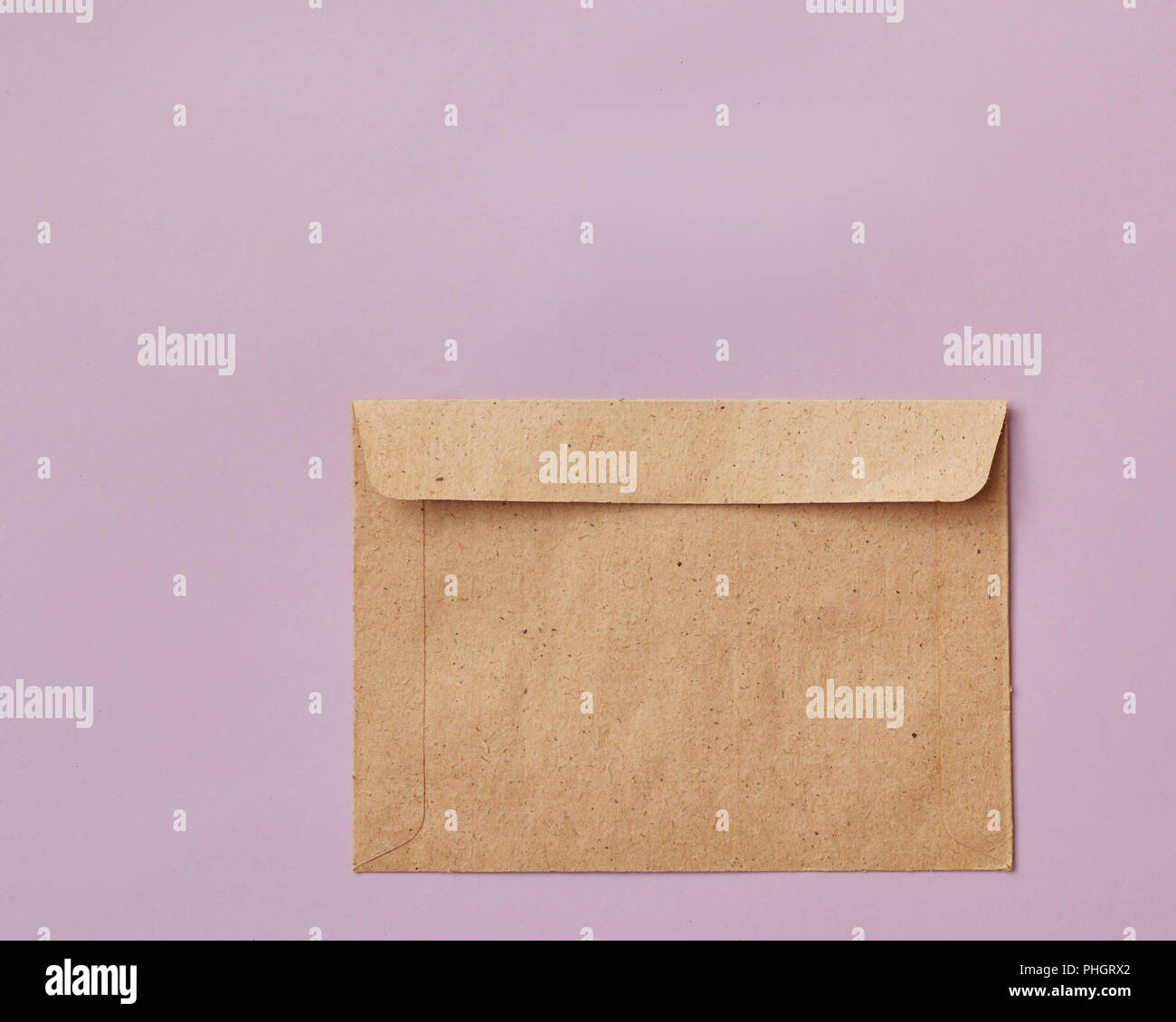 Brown craft envelope isolated on pink background Stock Photo