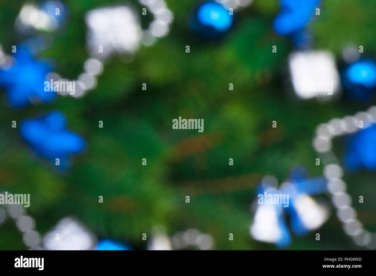 Christmas branch with blue decorations and garlands blurred and out of ...