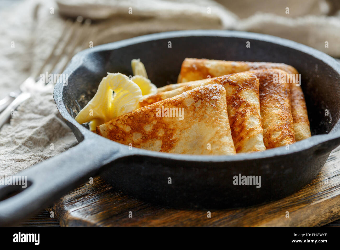 Delicious crepes with butter in a cast iron pan Stock Photo Alamy
