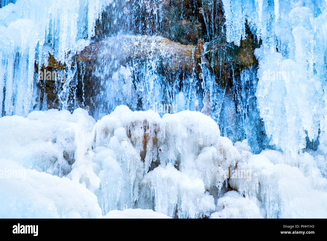 Frozen waterfall of blue icicles Stock Photo