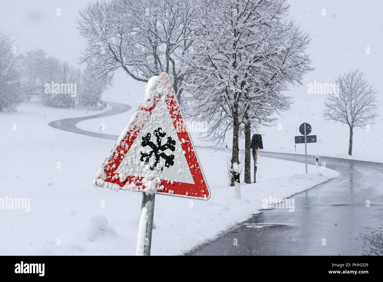 traffic sign warns of ice and snow on the road Stock Photo