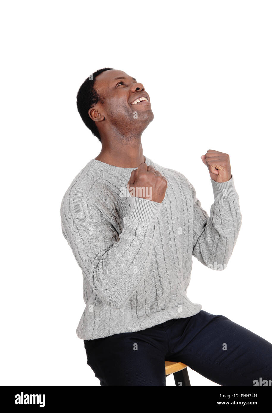 Happy African man with fists looking up Stock Photo