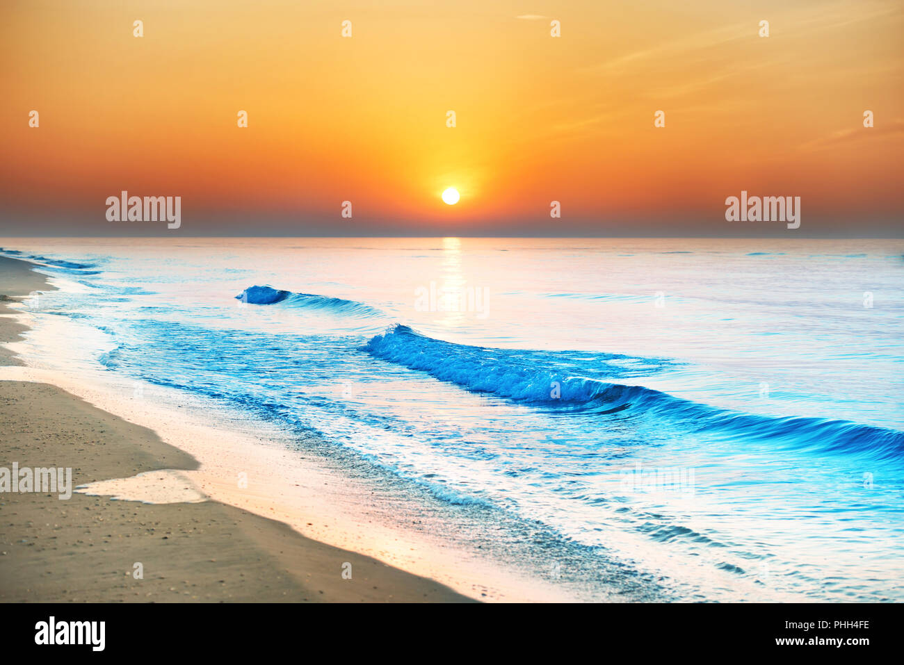 Sunset on the beach with long coastline Stock Photo