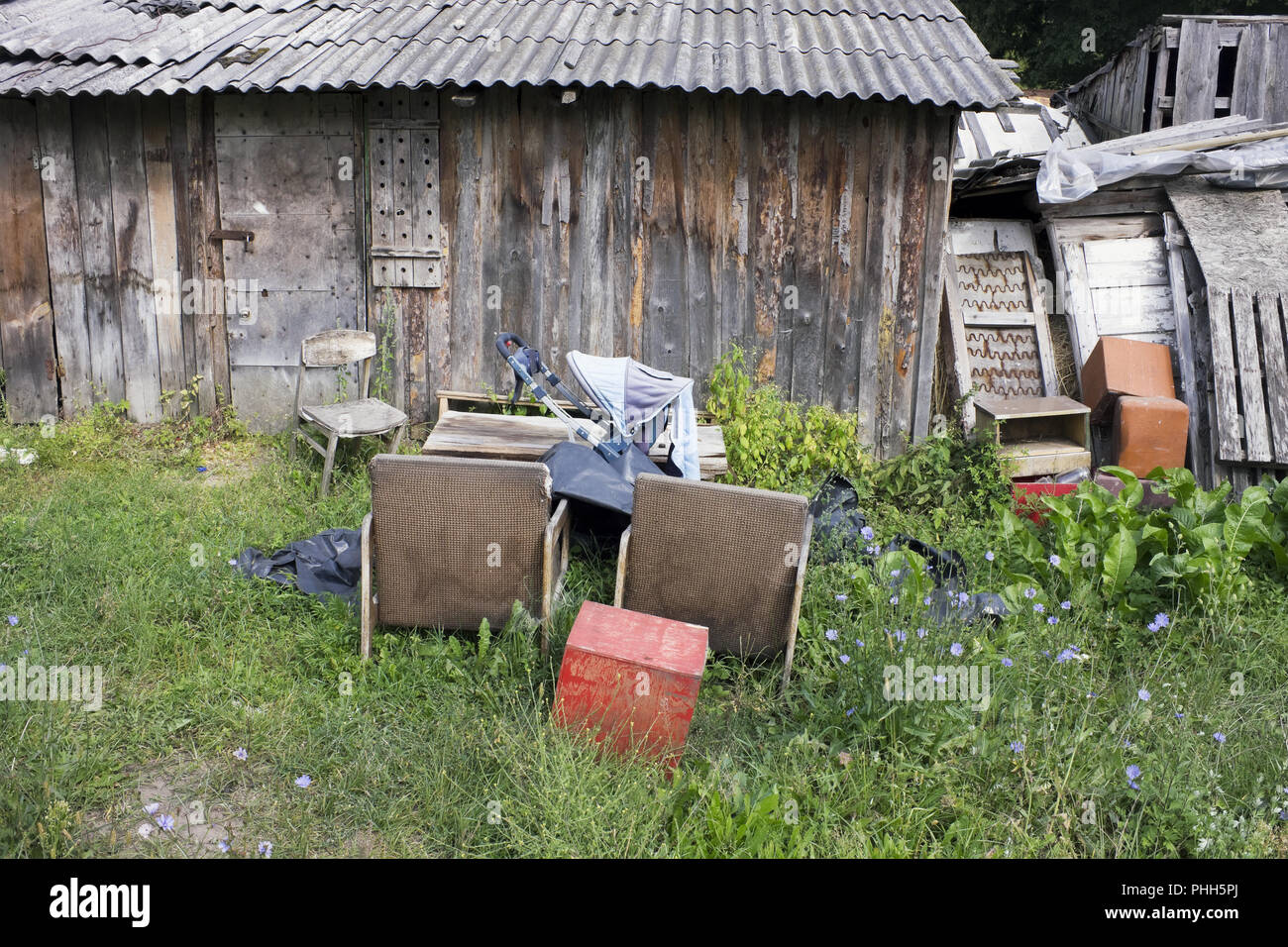 A village garbage dump near wooden destroyed sheds Stock Photo