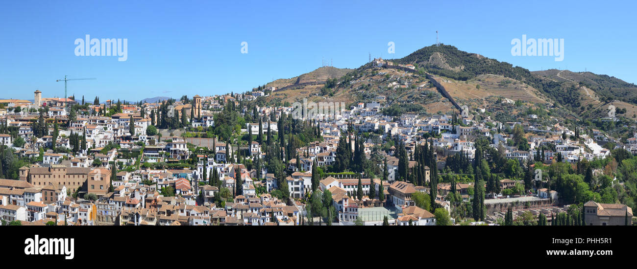 A blue spring sky over Spanish Granada town roofs. Stock Photo