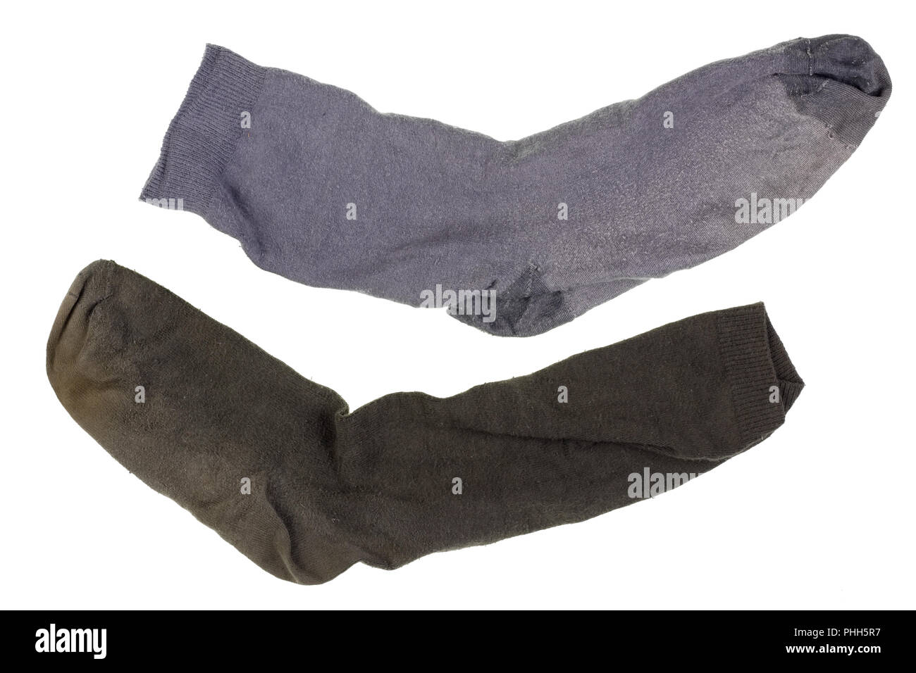 Two old ragged dirty dark  cotton socks. Stock Photo