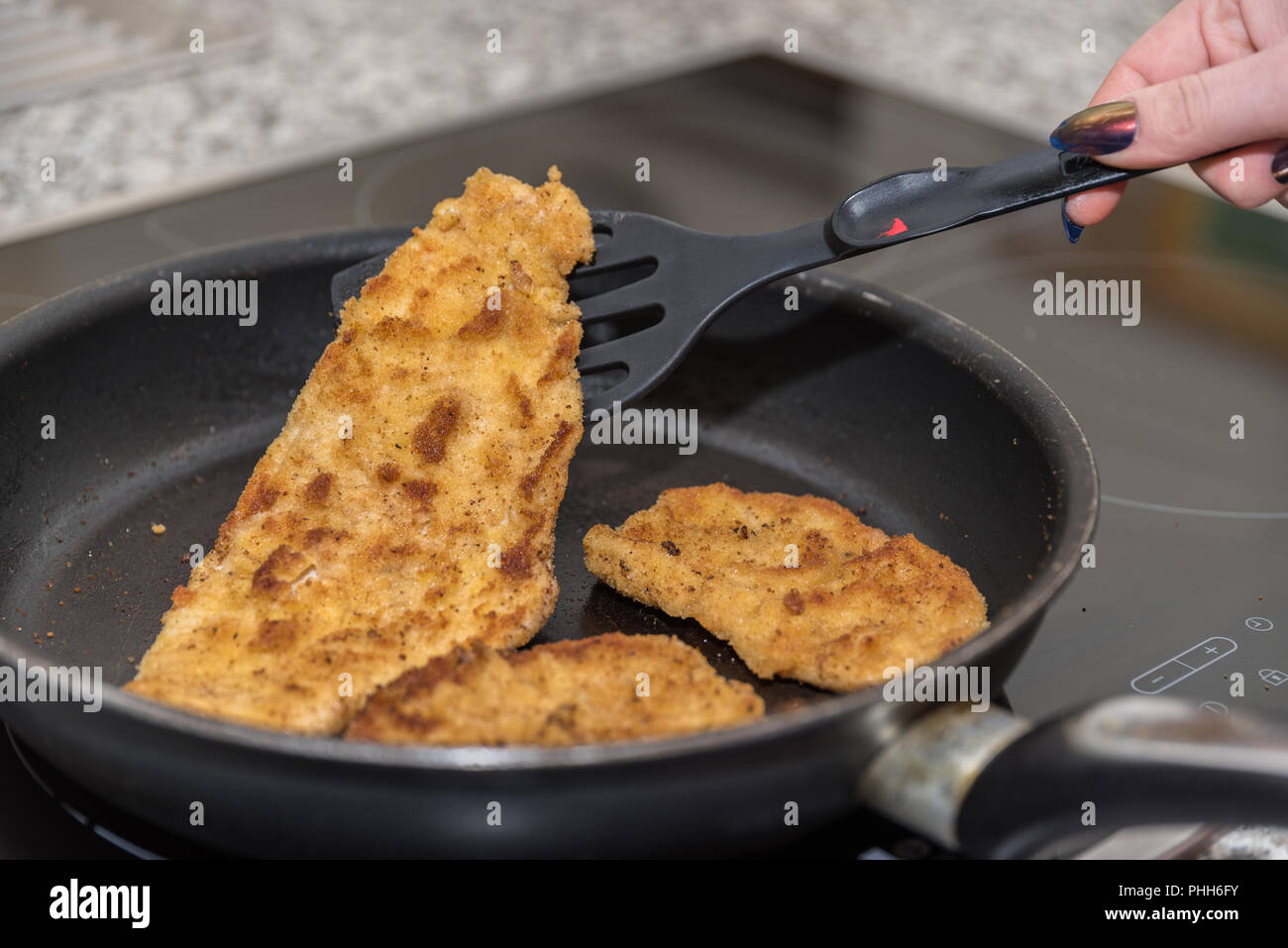Traditional food Veal schnitzel is prepared in a pan Stock Photo Alamy