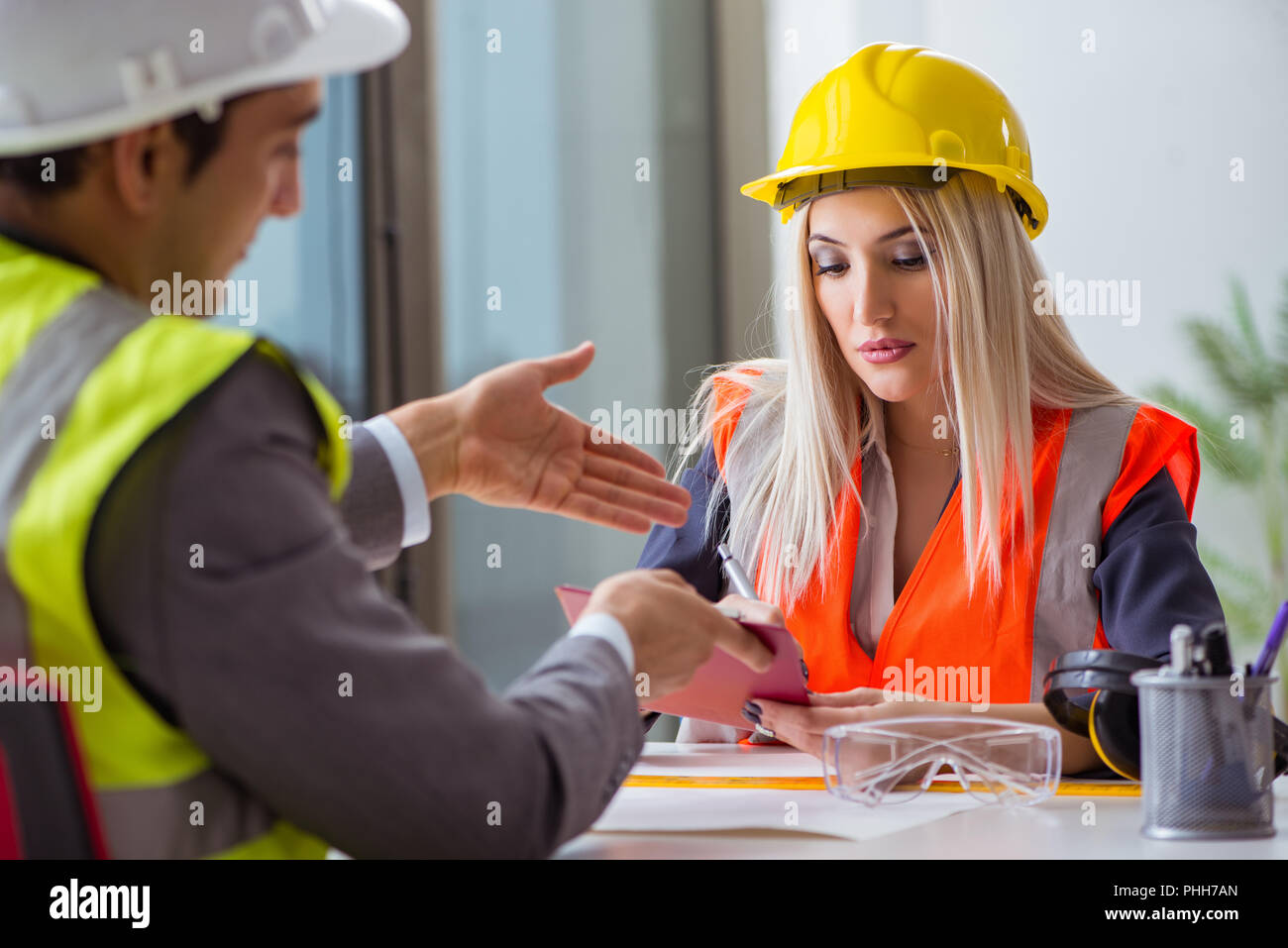 Construction workers having discussion in office before starting Stock ...