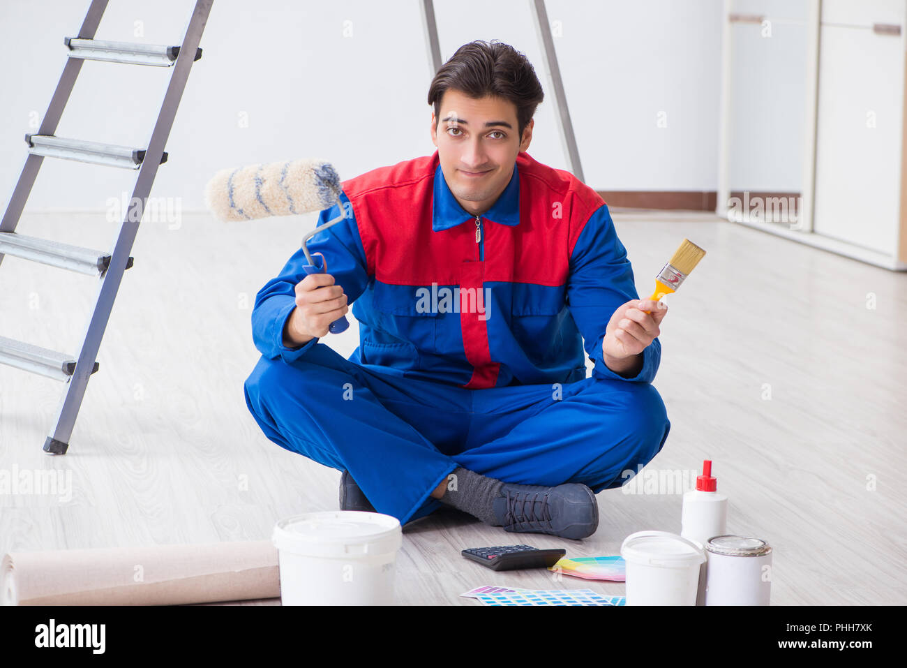 Young painter trying to match colours for painting job Stock Photo Alamy
