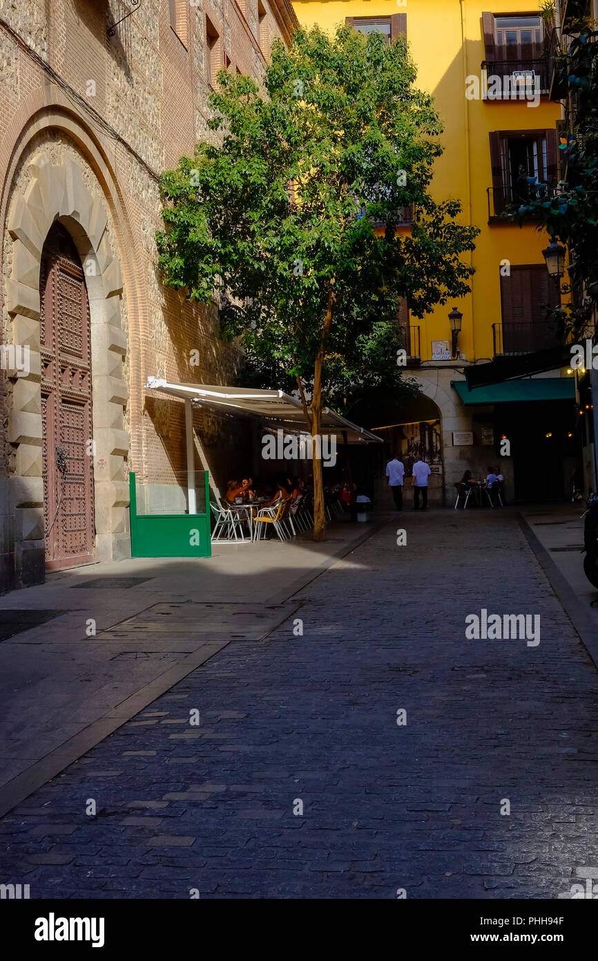 A view of View of Chocolateria San Gines from Plazuela de San Gines during the day with dark shades and bright sunlight hitting the back door of the p Stock Photo