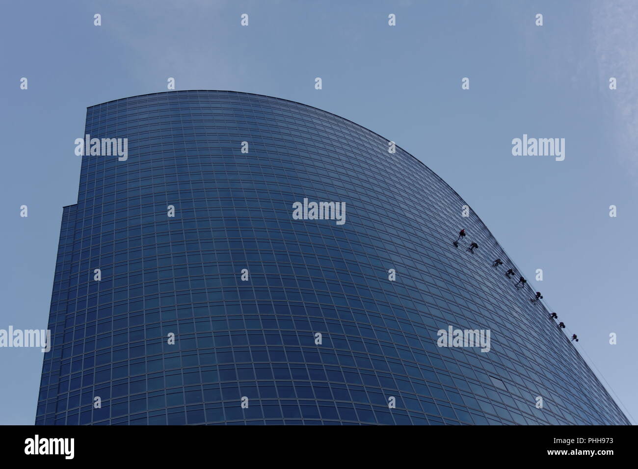 Windows washers cleaning glass facade of a high rise building Stock ...