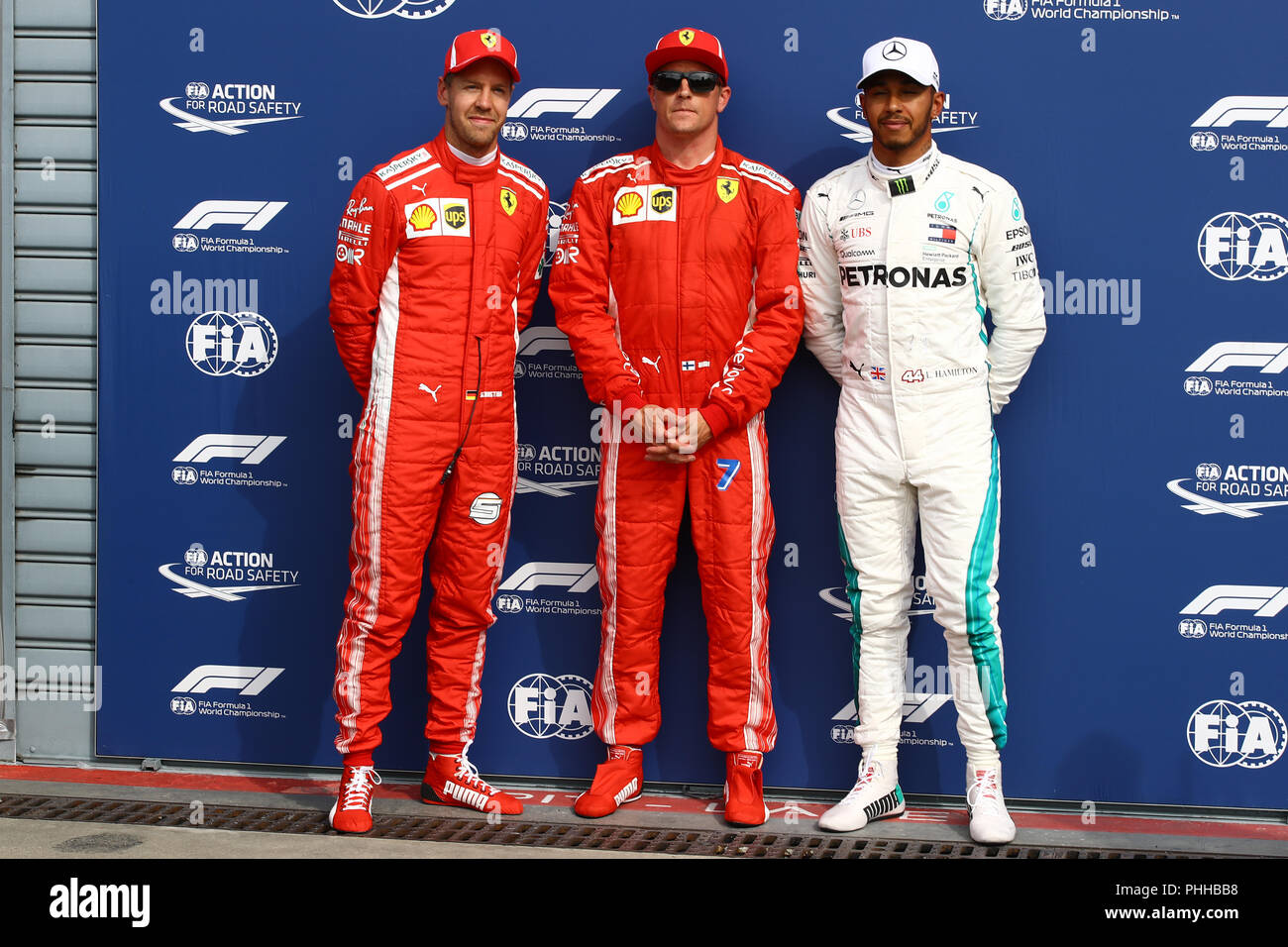 Monza, Italy. 1th September, 2018. Ferrari's Finnish driver Kimi Raikkonen (C) celebrates winning the pole position next to second placed Ferrari's German driver Sebastian Vettel (L) and third placed Mercedes' British driver Lewis Hamilton (R) after the qualifying session of the Formula One Grand Prix of Italy Credit: Marco Canoniero/Alamy Live News Stock Photo