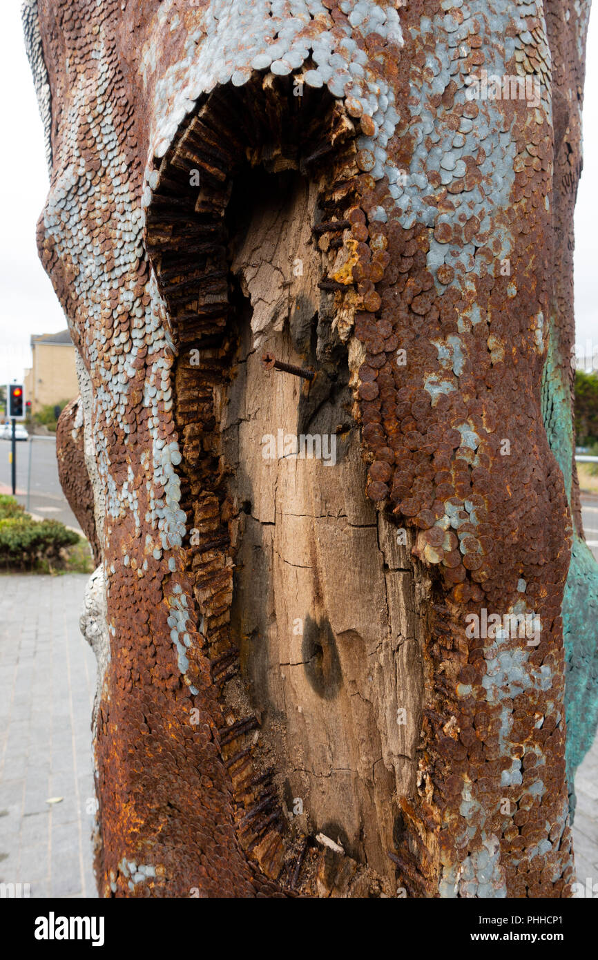 Kirkcaldy, Scotland, UK. 1 Sept, 2018. Wooden sculpture named Phantom by renowned Scottish artist David Mach has been cordoned off from the public following reports that debris is falling from the work. The wooden sculpture is made from a piece of driftwood with tens of thousands of nails driven into it and was commissioned by Morrisons supermarket for £35,000. Damage to the work is obvious but whether the fallen small pieces of wood and nails pose a risk to the public is open to debate. Credit: Iain Masterton/Alamy Live News Stock Photo