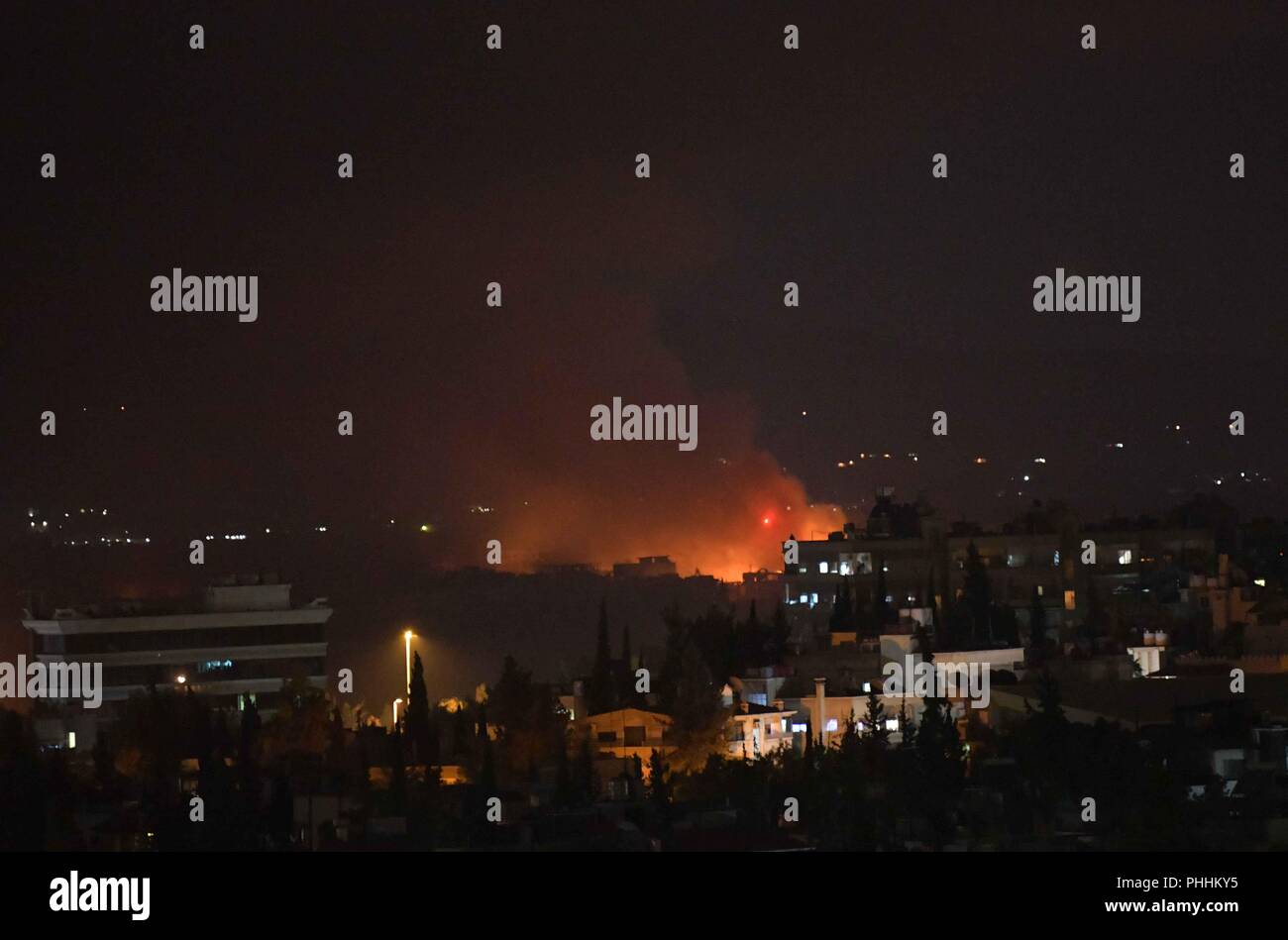 Damascus, Syria. 2nd Sep, 2018. Photo taken on Sept. 2, 2018 shows the fire and smoke rising from the Mazzeh airbase in the Damascus' western Mazzeh neighborhood, Syria, on Sept. 2, 2018. The Syrian army denied reports that an Israeli missile attack targeted a Syrian airbase west of Damascus early Sunday, saying a short circuit caused an explosion in an arms depot near the airbase, according to the state TV. Credit: Ammar Safarjalani/Xinhua/Alamy Live News Stock Photo