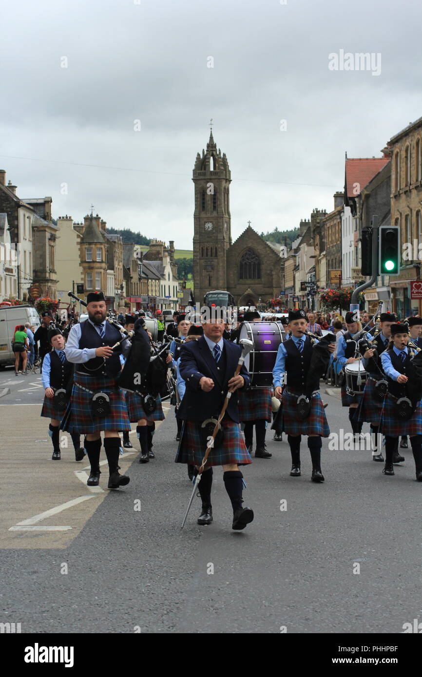 Pipe and Drums Bands Street Parade. Pipers and drummers playing and marching  through the streets of Peebles to finish Highland Games. 1st September 2018, Peebles, Scotland, United Kingdom Stock Photo