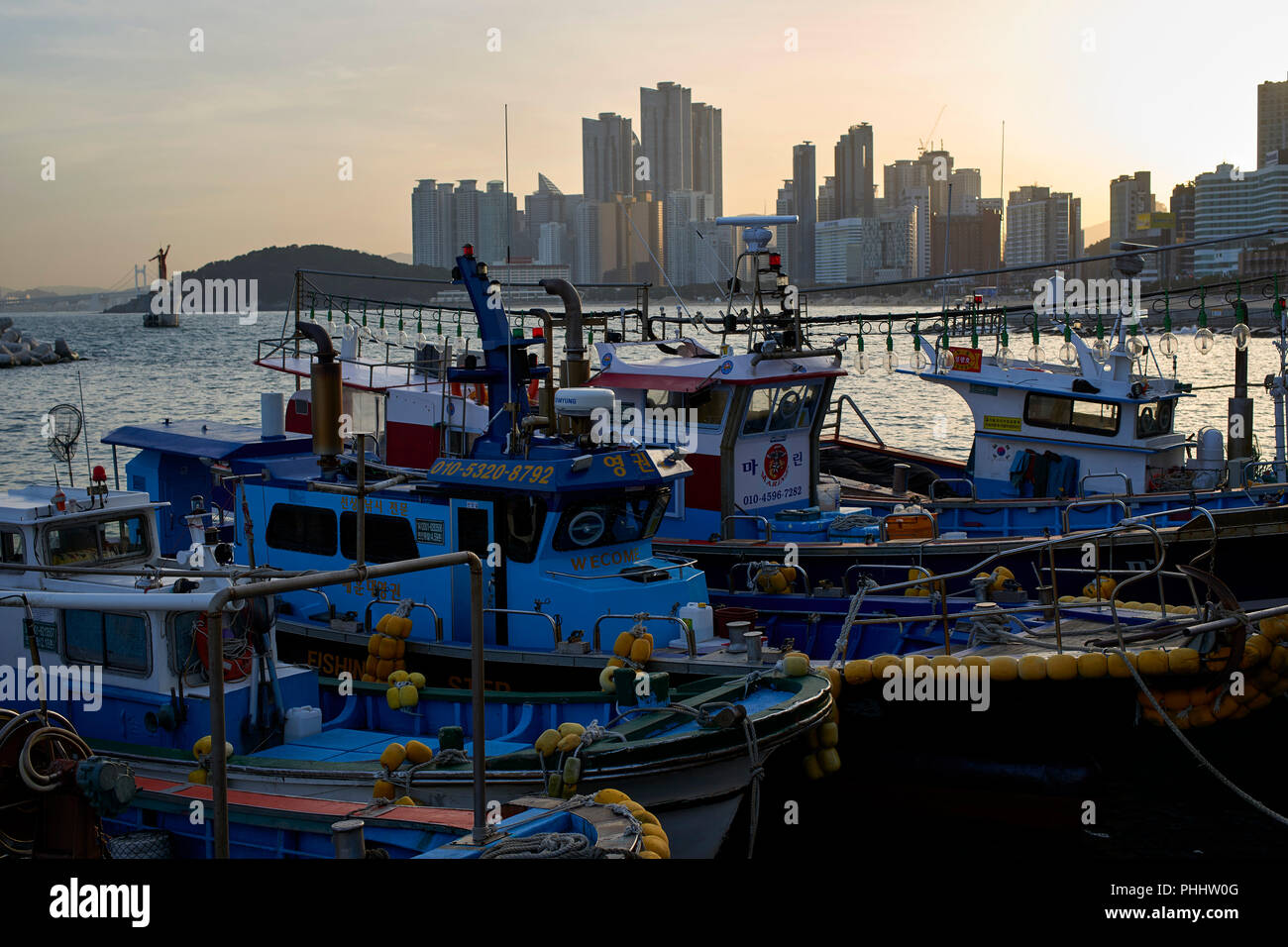 Moored fishing boats in the small harbour in Haeundae Bay, Busan Korea. Stock Photo