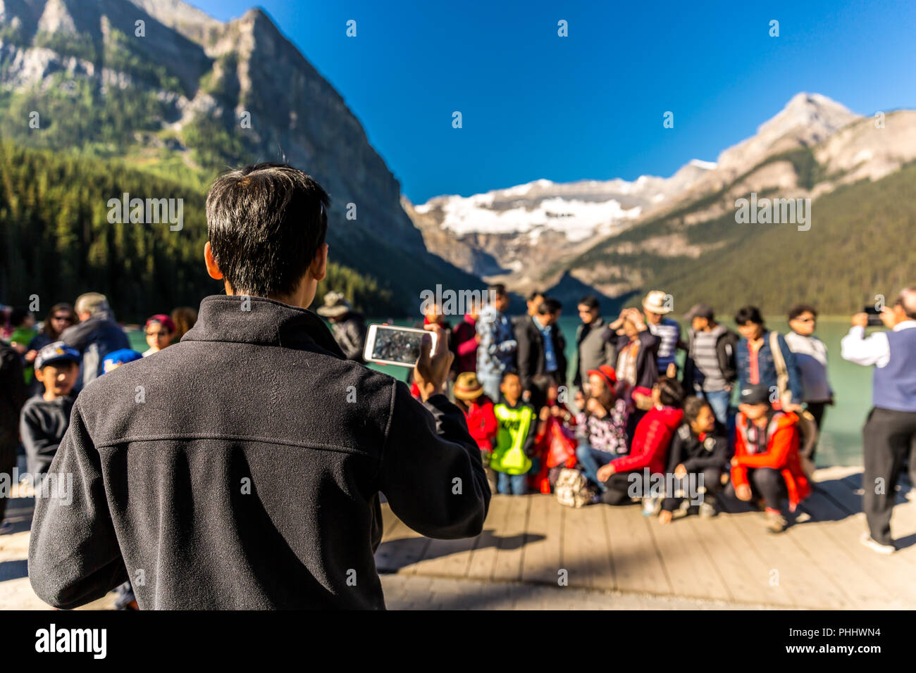 Banff, Canada - Ago 17th 2018 - A chinese group taking a group picture in front of the Lake Moraine in Banff National Park in Canada Stock Photo