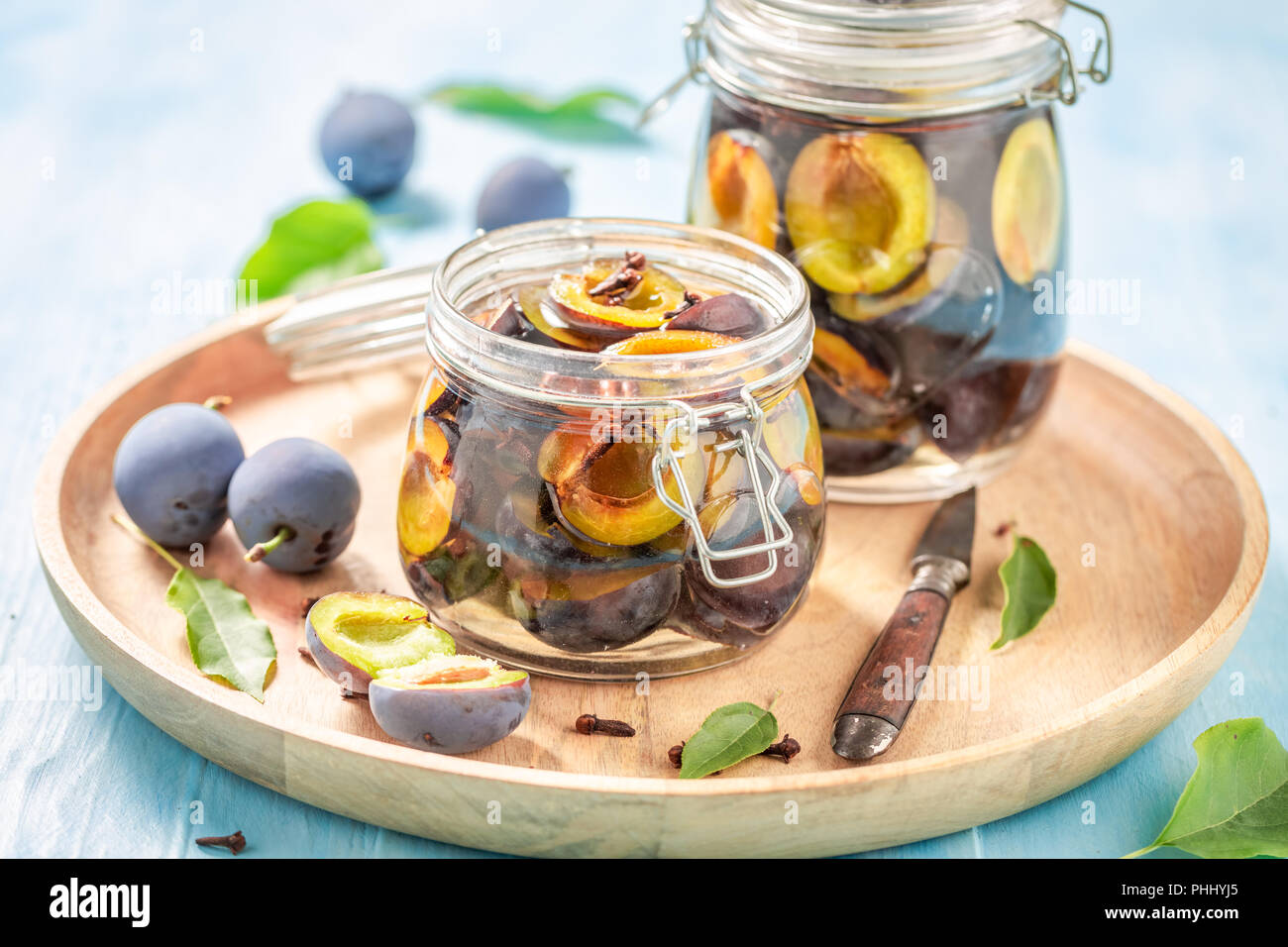 Tasty pickled purple plums in the jar Stock Photo - Alamy