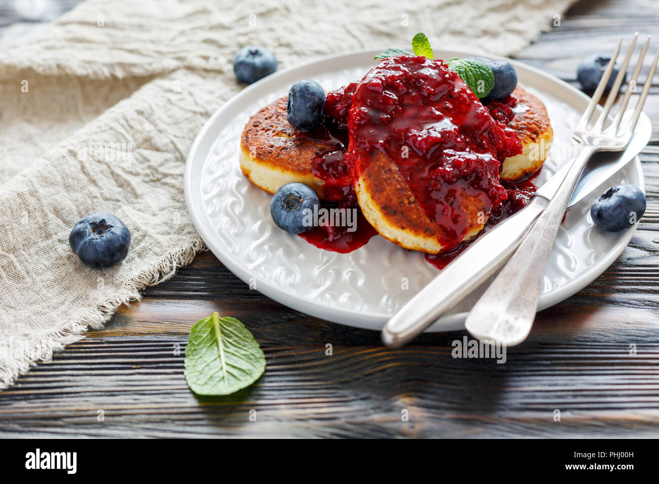 Cheese pancakes and blueberries in white plate. Stock Photo