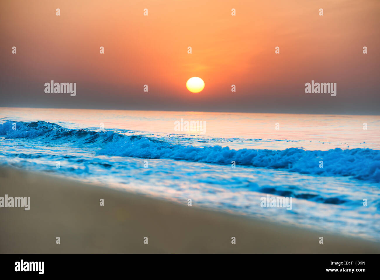 Sunset on the beach with long coastline Stock Photo