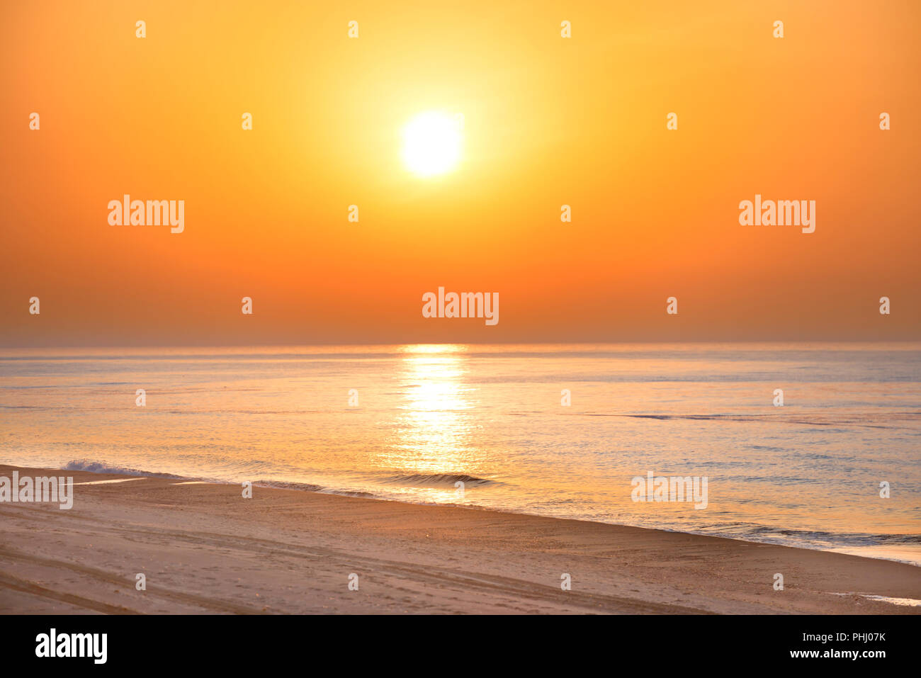 Sunset on the beach with long coastline Stock Photo
