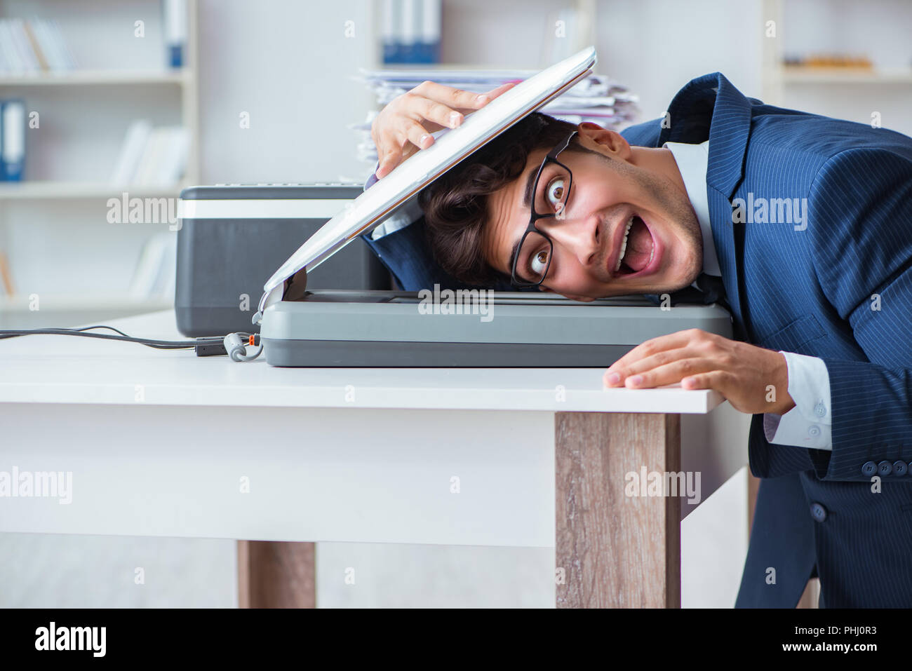 Businessman making copies in copying machine Stock Photo - Alamy