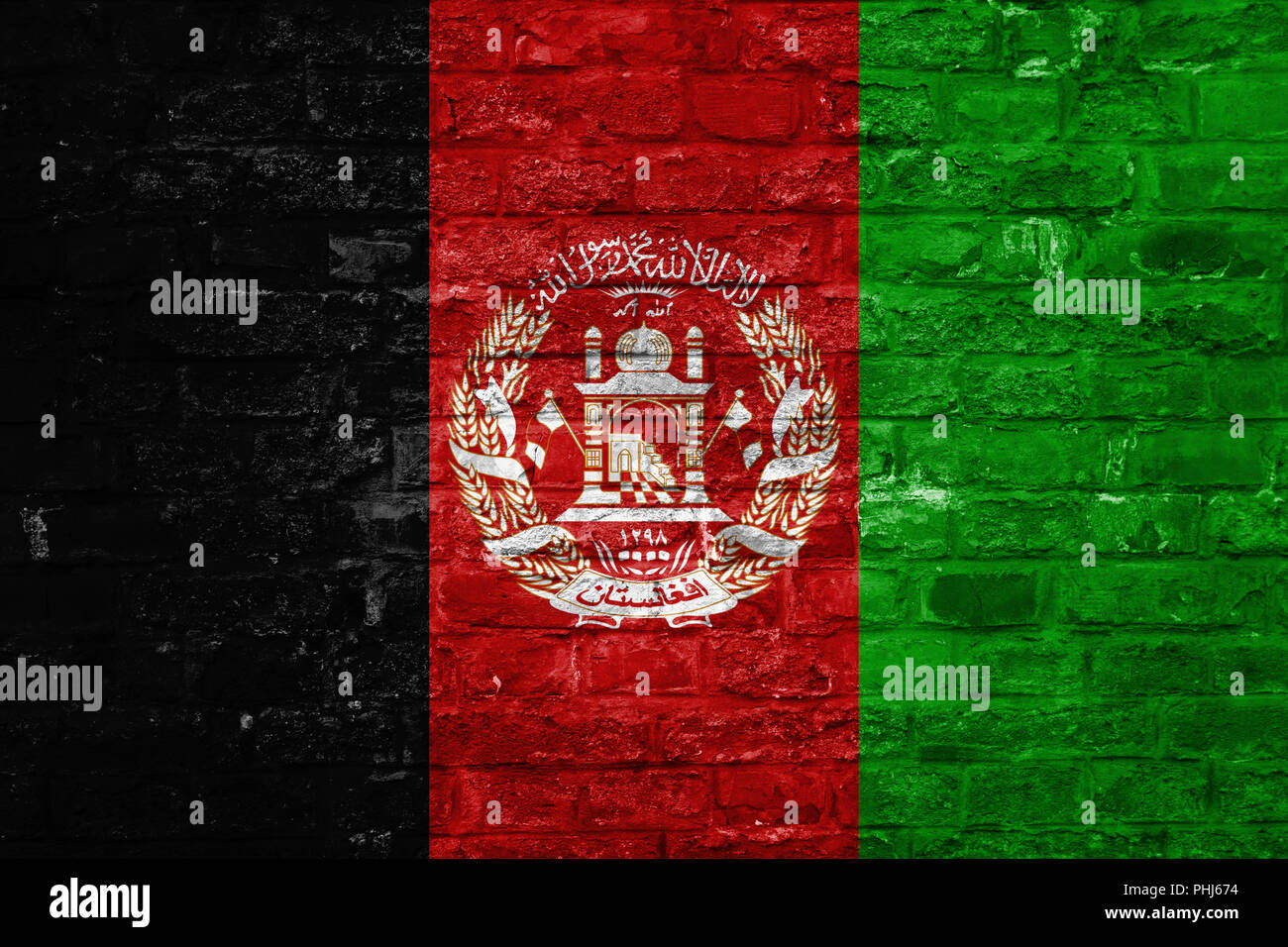 Flag of Afghanistan over an old brick wall background, surface Stock Photo