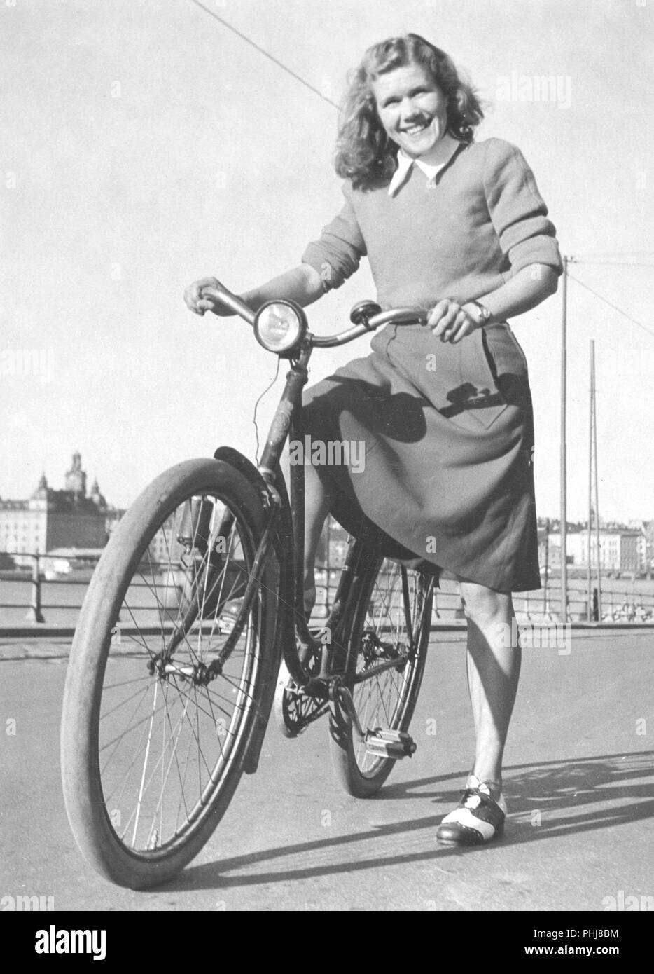 1940s woman on a bicycle. A smiling young woman on a womens bicycle on a sunny day. Swedish runner Anna Larsson. 1922-2003. Holder of four world records.  Sweden 1940s Stock Photo