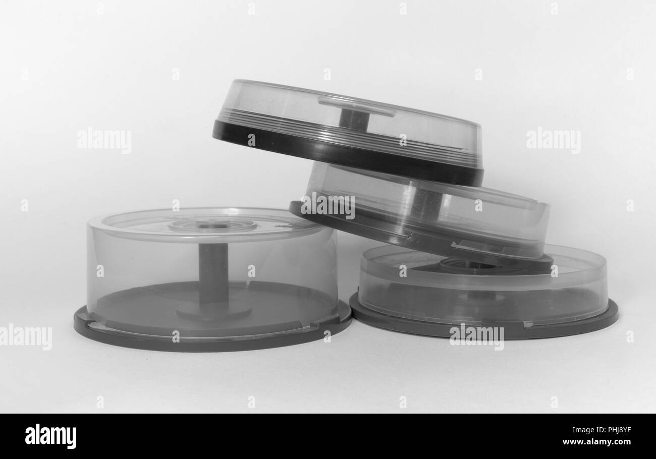 disc cake box. pile of transparent storages with spindel for CDs black and white Stock Photo