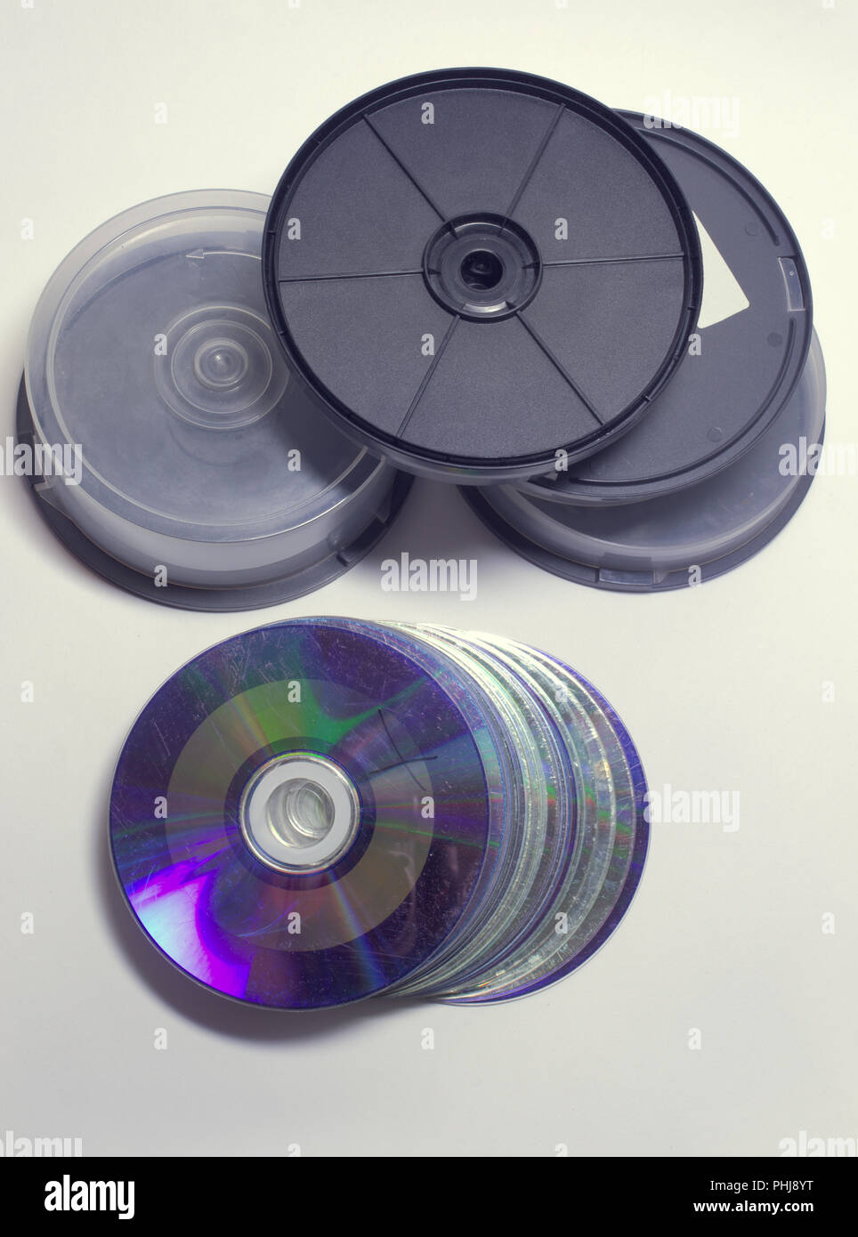 disc cake boxes with threaded transparent covers and solid black plastic bottoms. heap of empty storages and stack of used corrupted disks Stock Photo