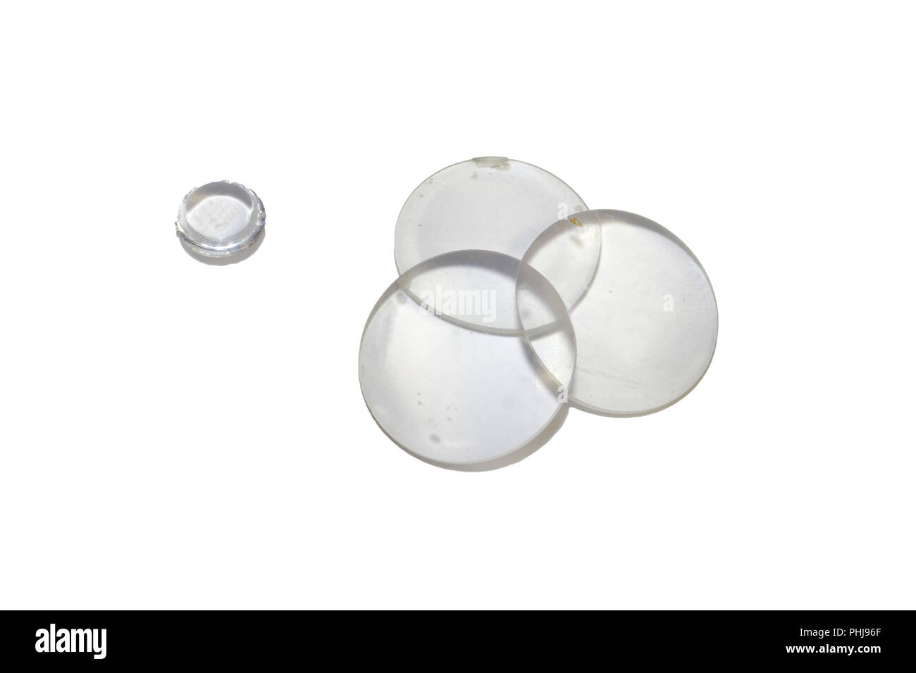 set of flat-convex glass optical magnifying lenses and a small double-convex lens isolated with clipping path Stock Photo