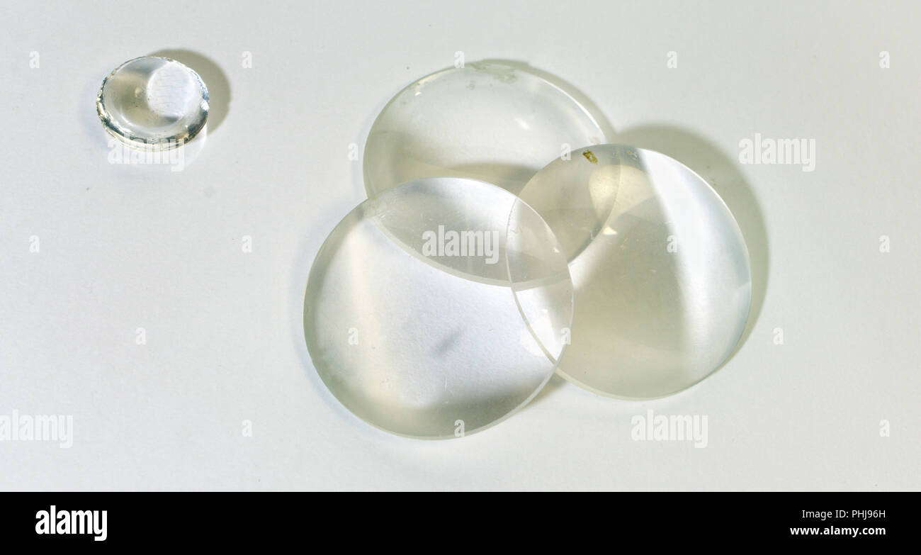 flat-convex glass optical magnifying lenses set and a small double-convex lens closeup Stock Photo
