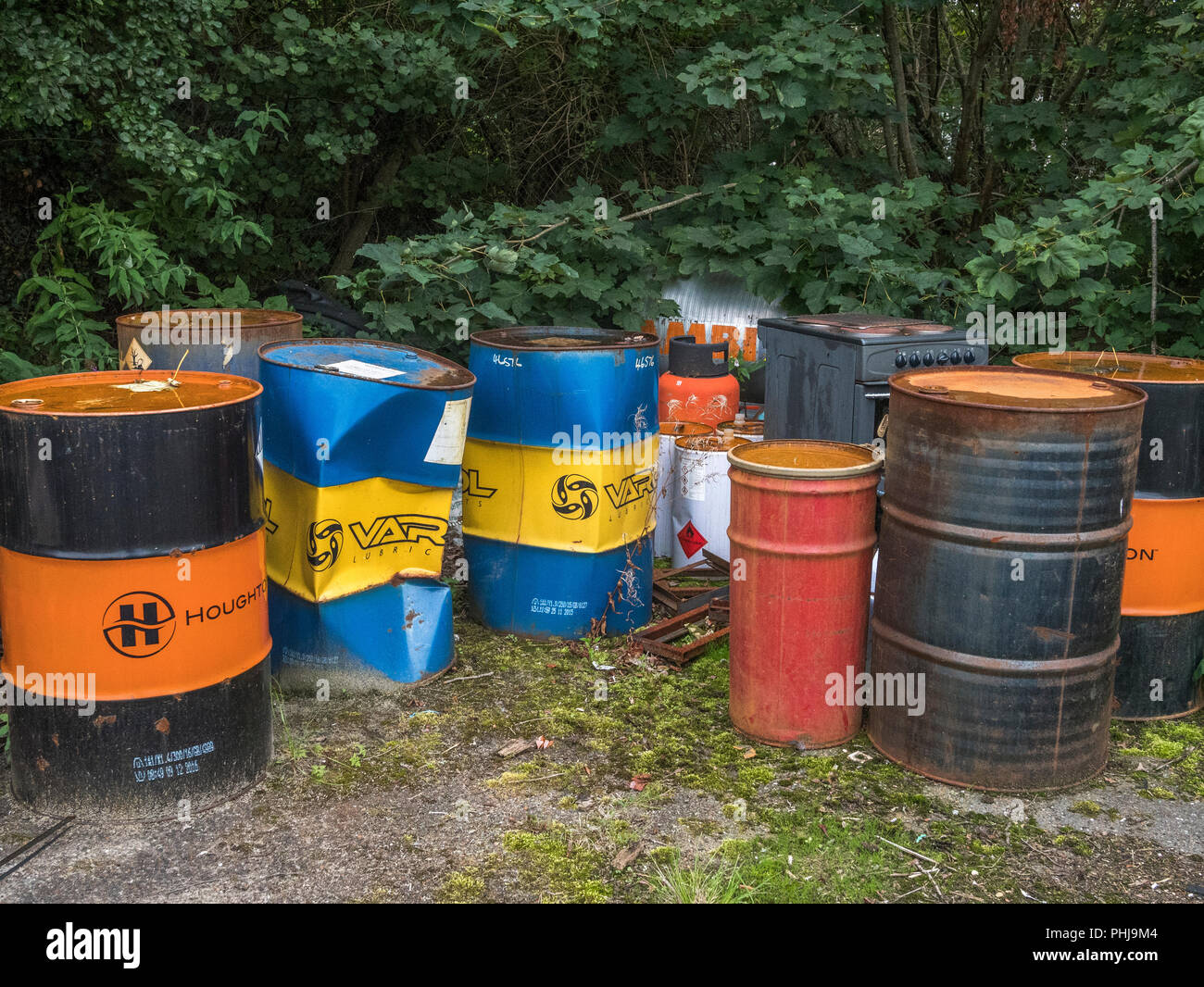 Empty industrial lubricant steel barrels awaiting disposal Stock Photo