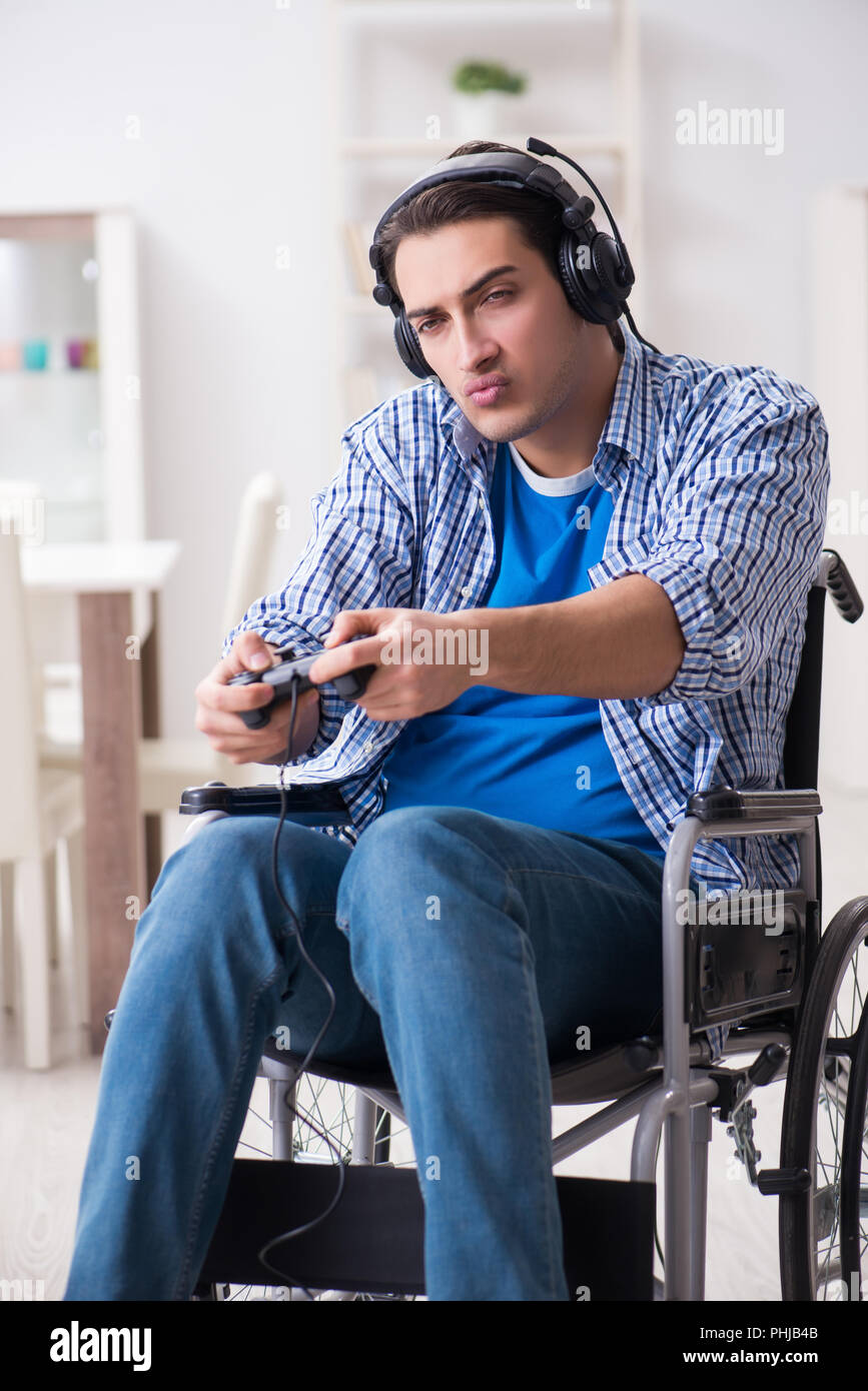 Disabled man playing computer games during rehabilitation Stock Photo