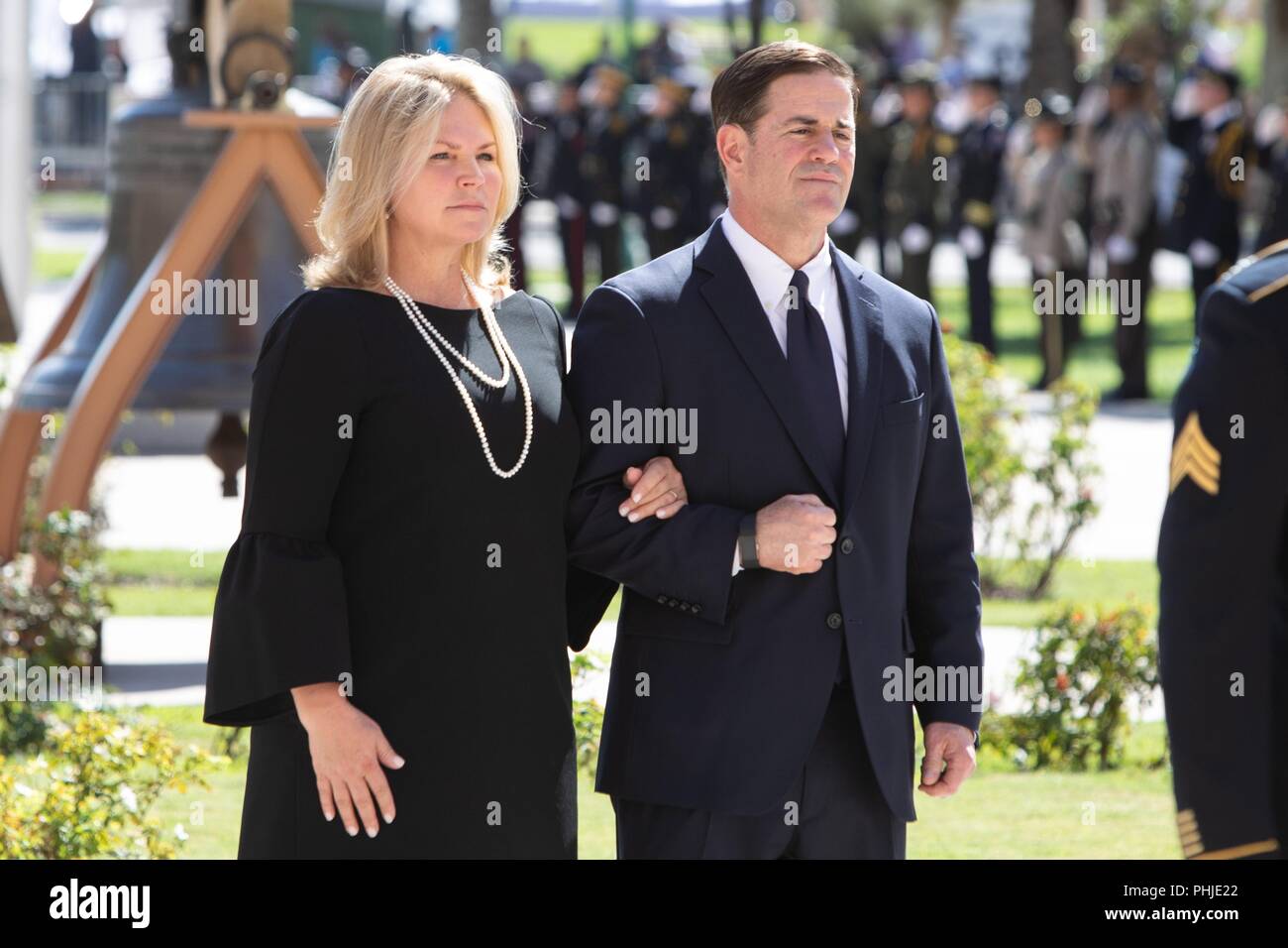 Arizona Gov. Doug Ducey and his wife Angela Ducey, arrive for the memorial service for Sen. John McCain at the North Phoenix Baptist Church August 29, 2018 in Phoenix, Arizona. The former senator’s remains will lie in state in the U.S. Capitol Rotunda before burial at the U.S. Naval Academy. Stock Photo
