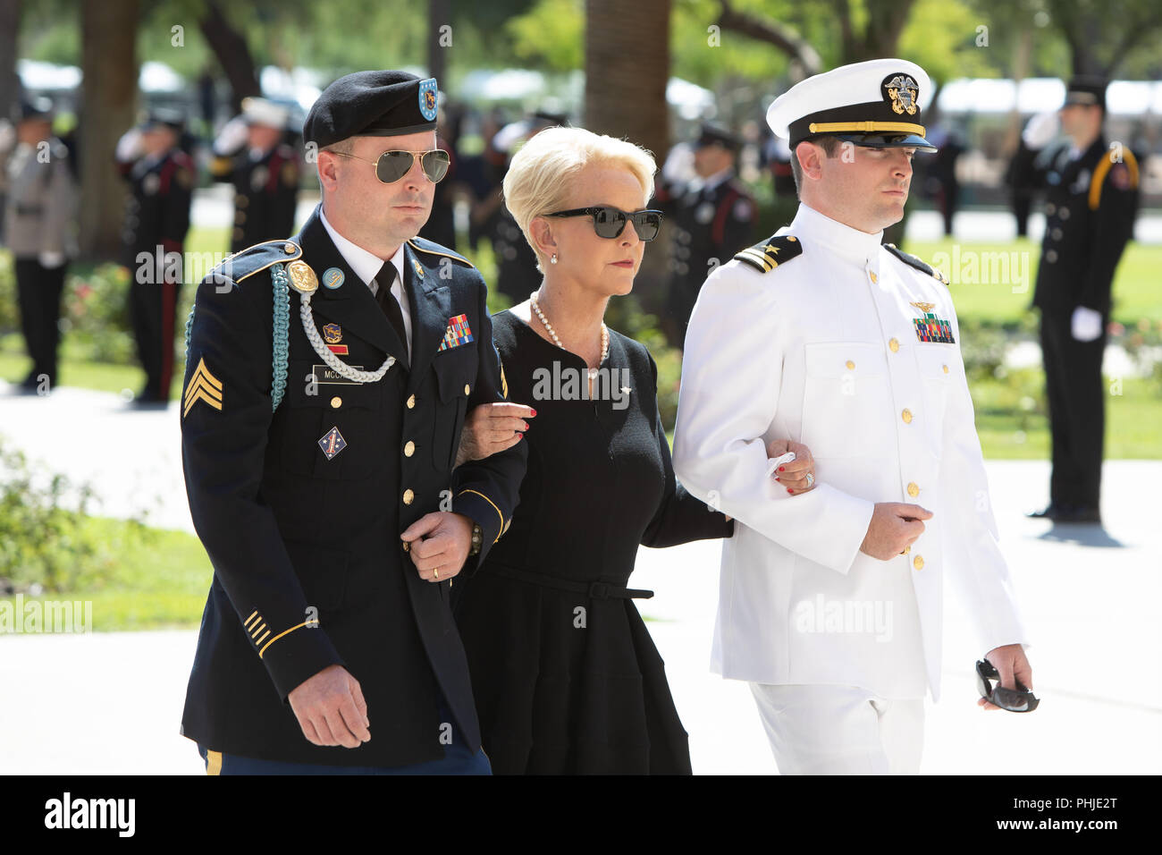 Cindy McCain, wife of Senator John McCain is escorted by her sons, Navy Lt. Jimmy McCain (left) and Arizona Army National Guard Sgt. Jack McCain (right) as they arrive for the memorial service for her at the North Phoenix Baptist Church August 29, 2018 in Phoenix, Arizona. The former senator’s remains will lie in state in the U.S. Capitol Rotunda before burial at the U.S. Naval Academy. Stock Photo