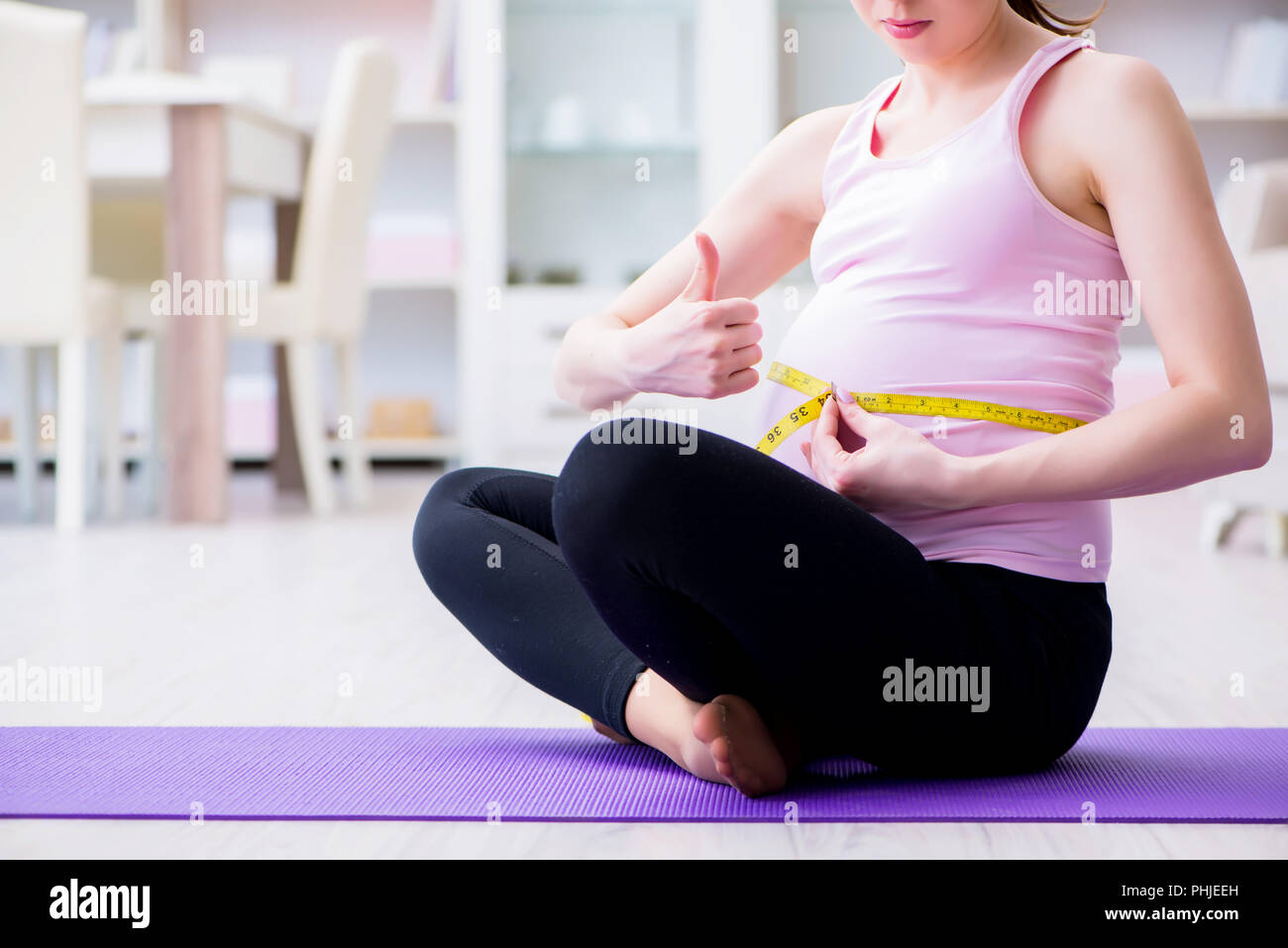 Fit woman exercising with gymnastics rings at a gym, a health club