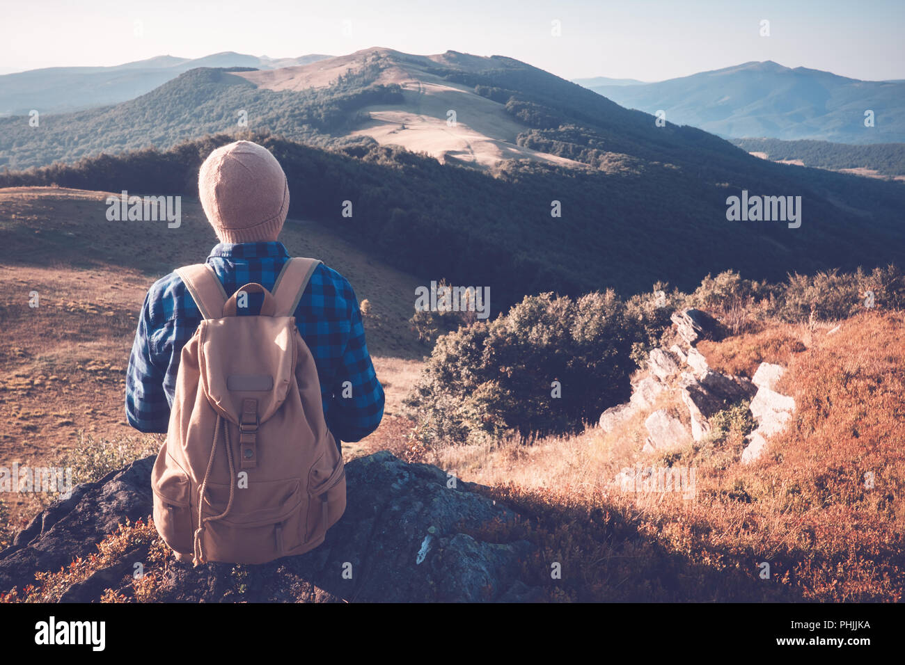 Man with backpack on mountains road Stock Photo