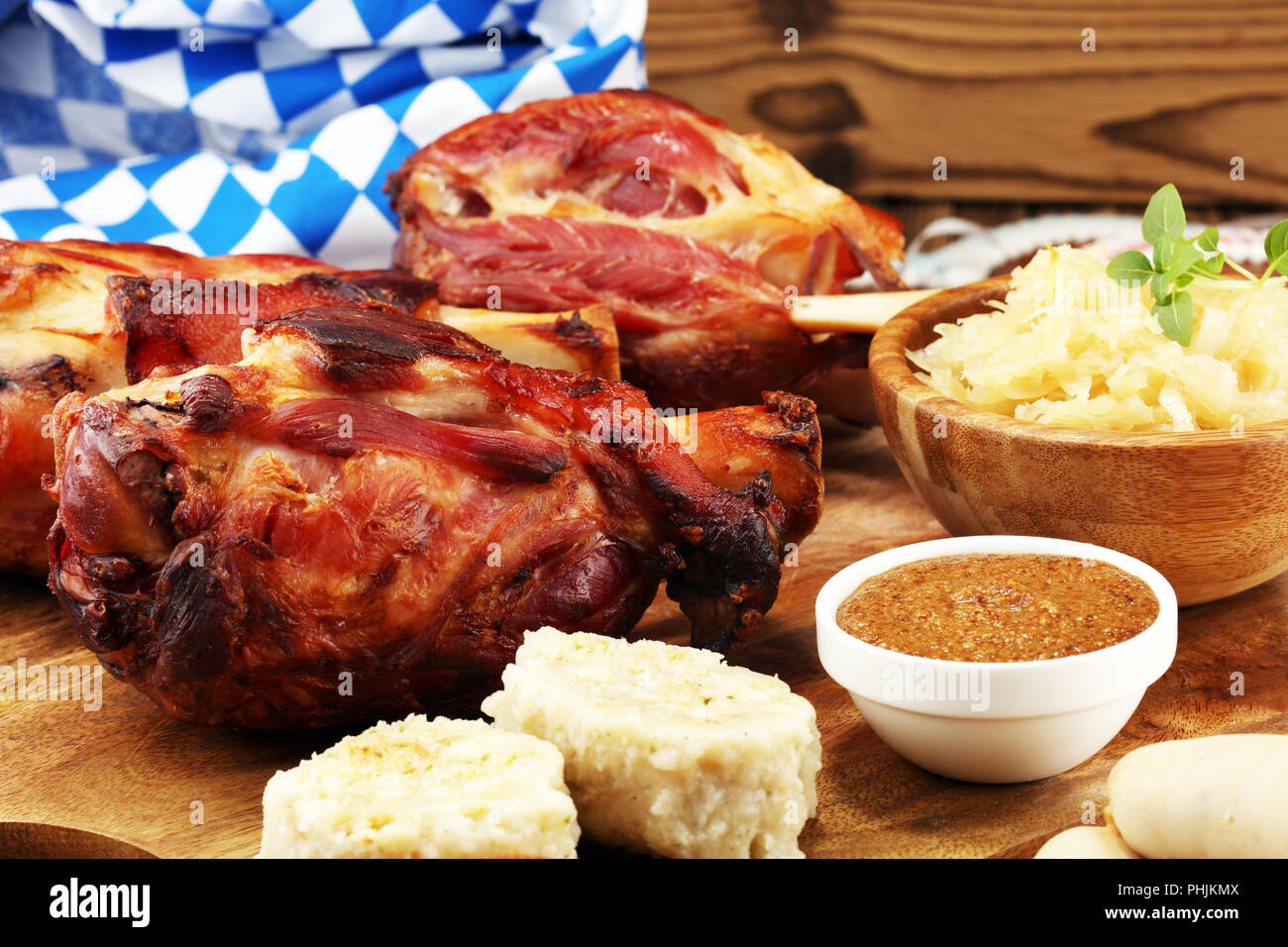 Traditional German cuisine, Schweinshaxe roasted ham hock. Beer, pretzels and various Bavarian specialties. Oktoberfest background Stock Photo
