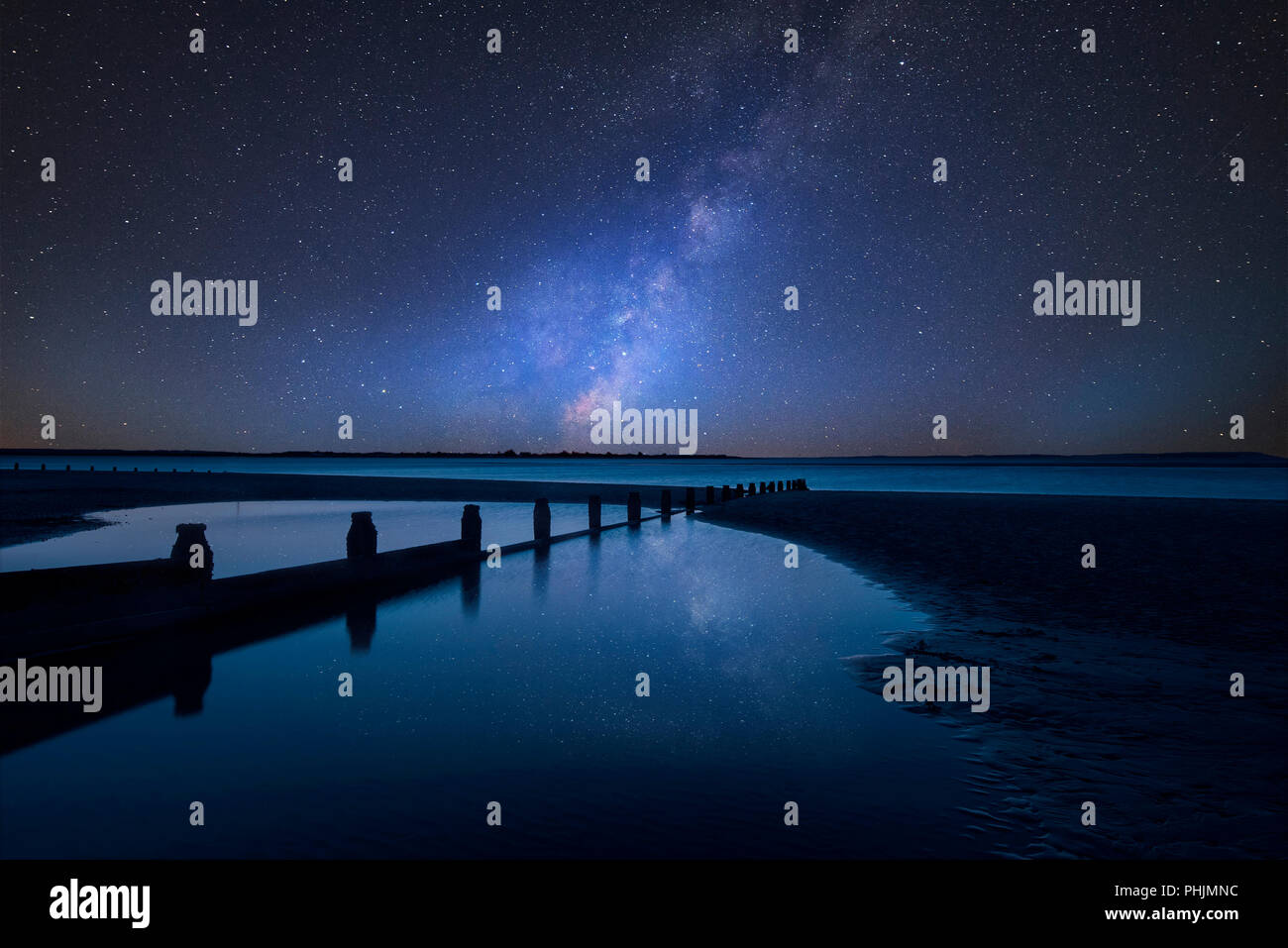 Stunning vibrant Milky Way composite image over landscape of Beautiful ...