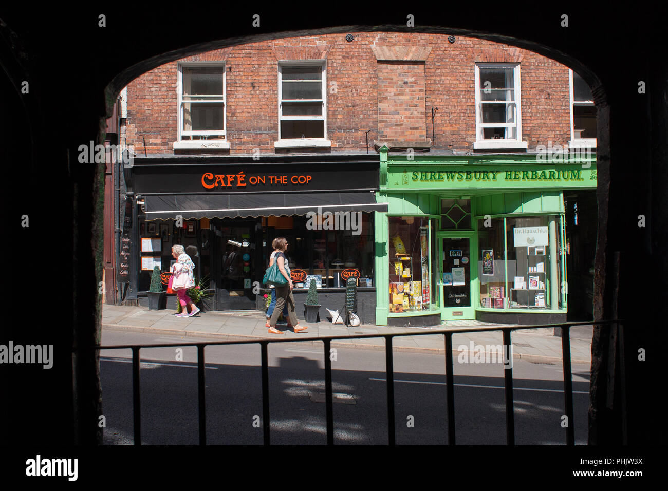 View showing two independent shops on Wyle Cop in the centre of Shrewsbury, Shropshire, 2016. Some people are walking past the shops. Stock Photo