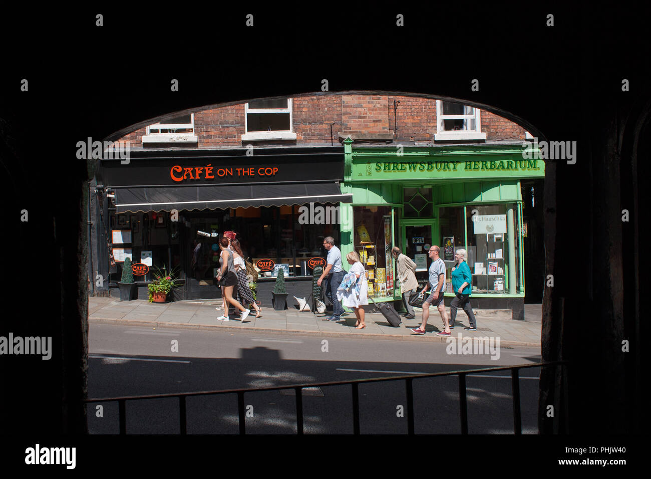 View showing two independent shops on Wyle Cop in the centre of Shrewsbury, Shropshire, 2016. Some people are walking past the shops. Stock Photo