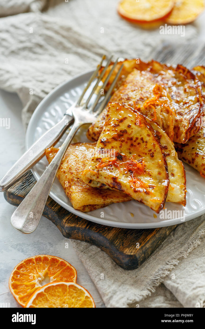 Pancakes with sweet orange sauce, crepes Suzette. Stock Photo