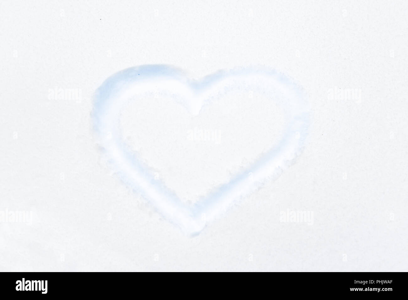 Blue heart shape drawing on white snow Stock Photo - Alamy