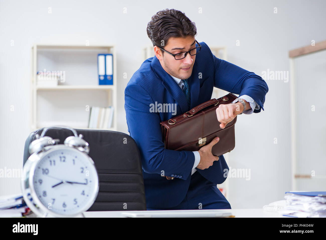 Businessman in bad time management concept Stock Photo